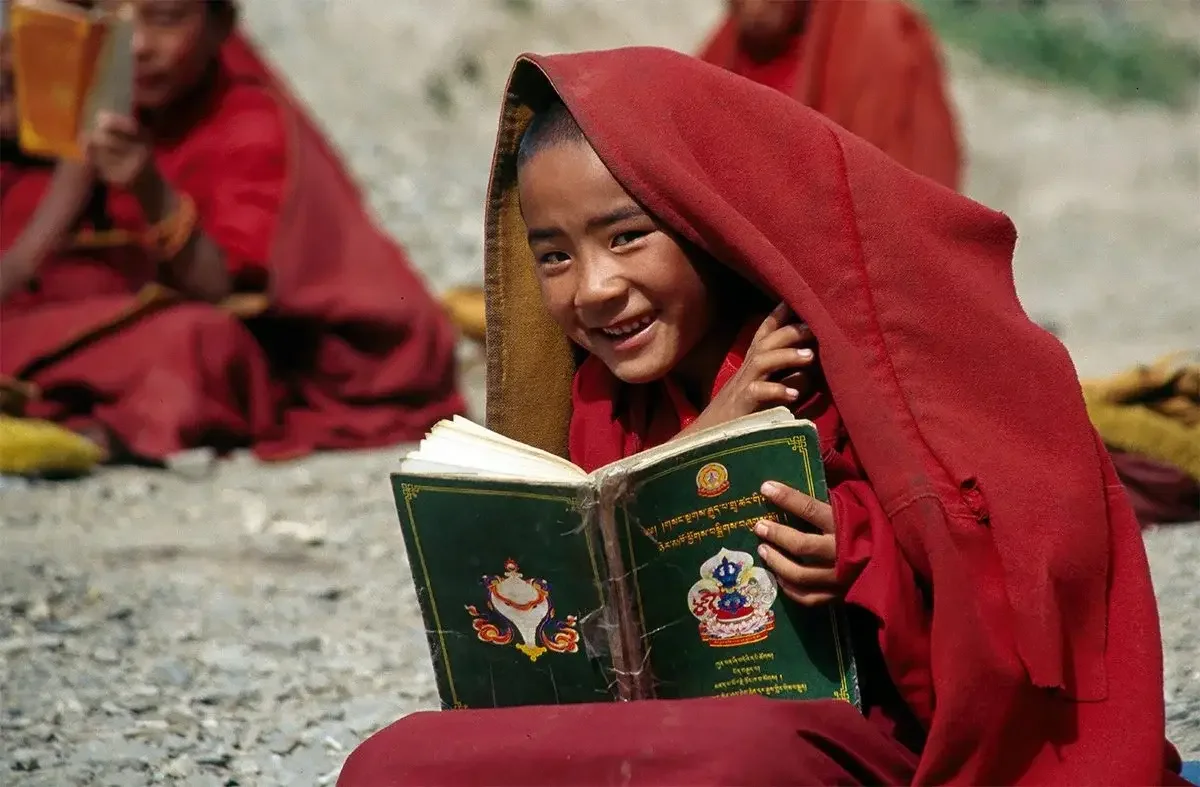 Buddhist novice with Buddhist text