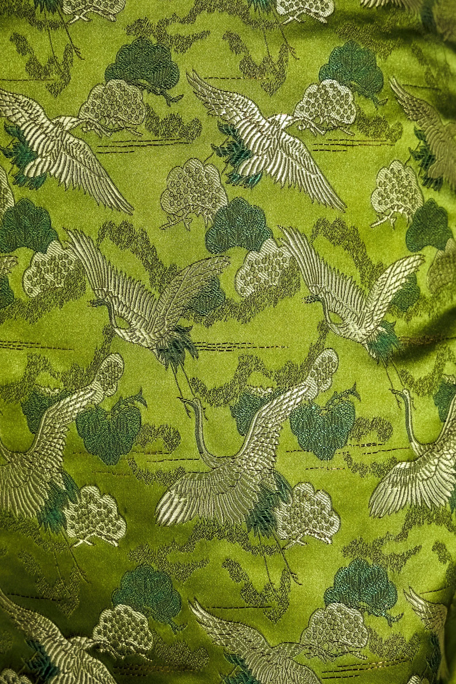 Close-up of Japanese cranes and pine trees jacquard print on olive green fabric — Japan Origami by B.Brand