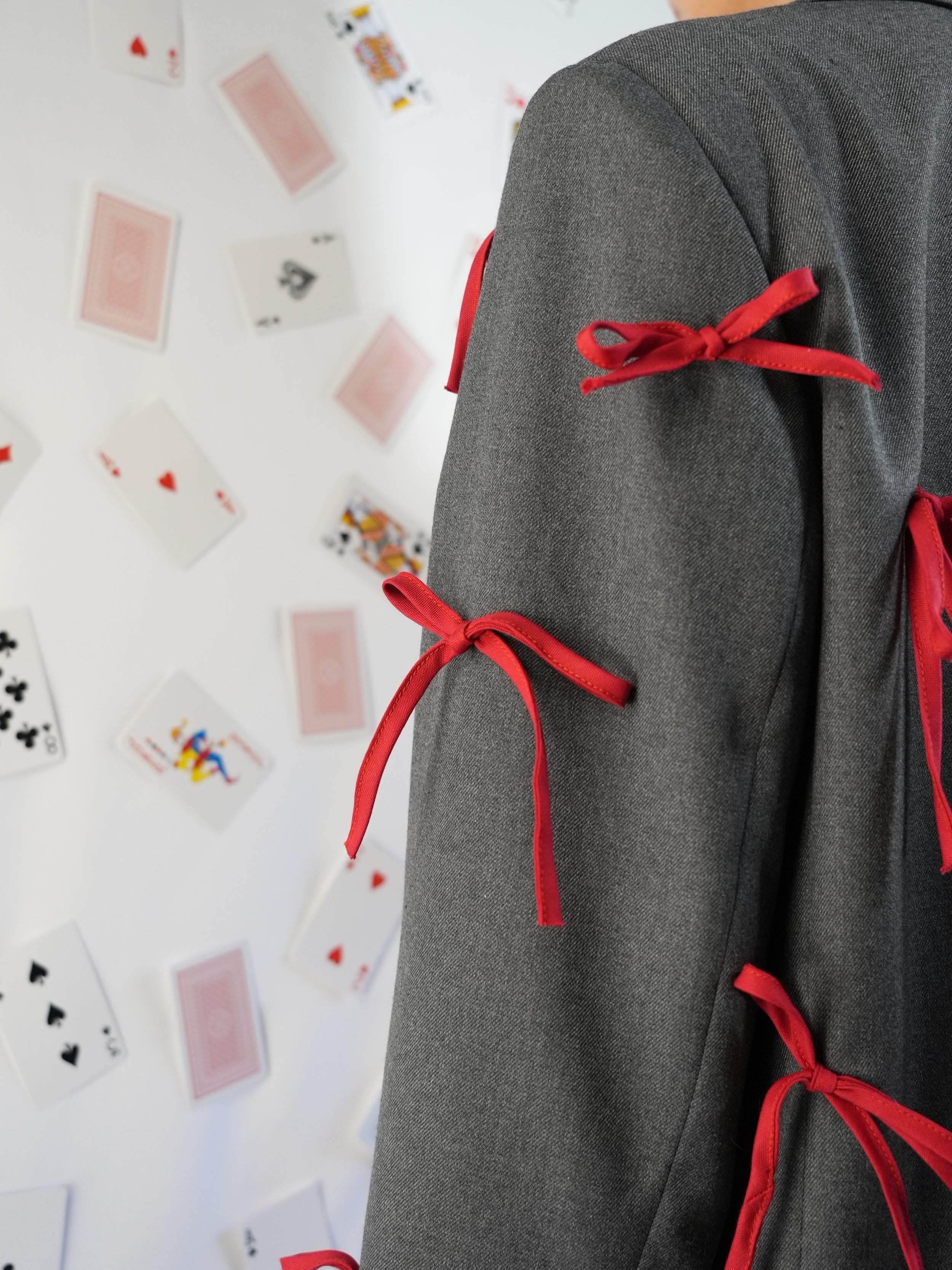 B.Brand Gray Jacket Red Bow — detail view: removable red bow close-up on gray jacket