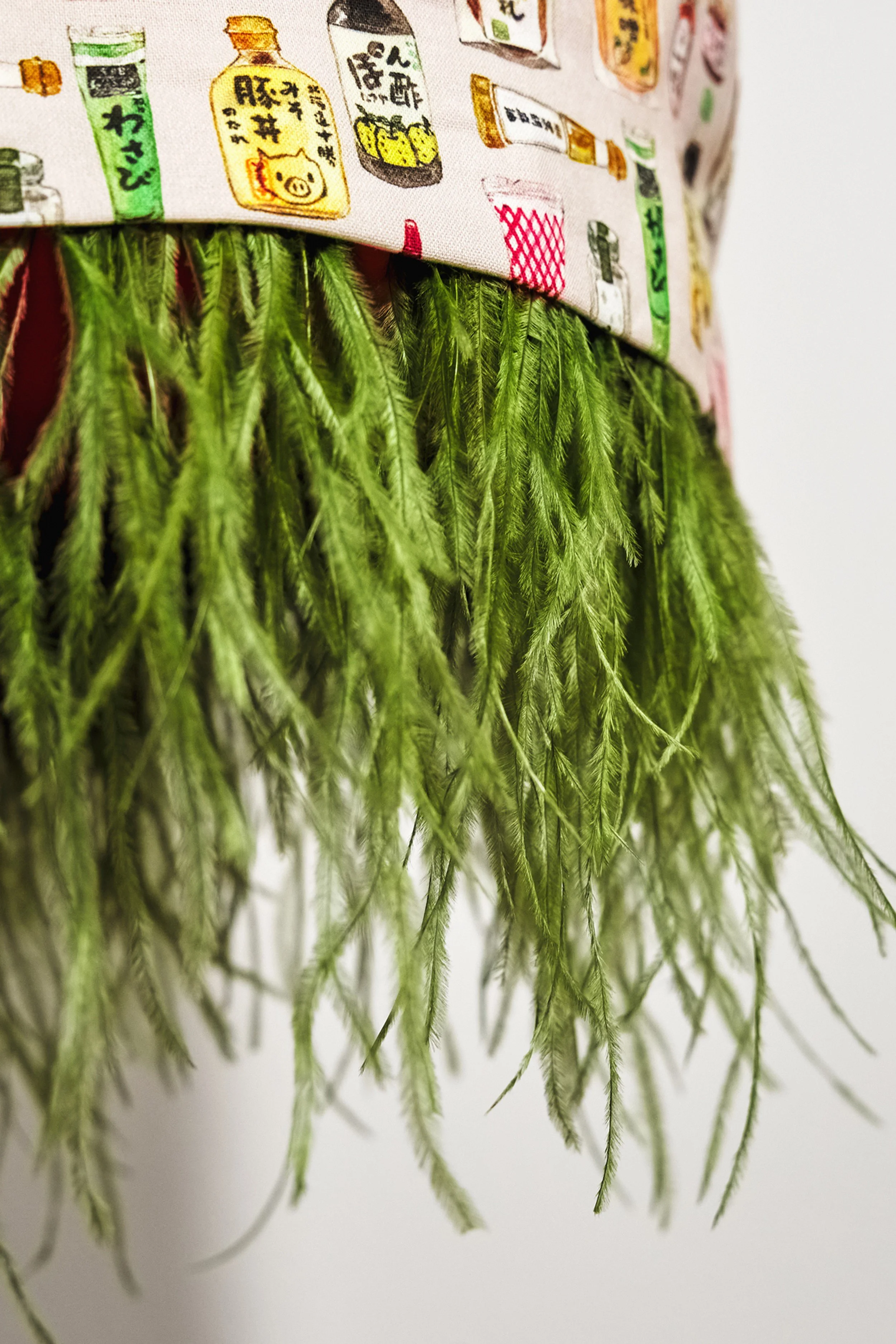 Close-up of detachable wasabi-green feather hem on Japanese print skirt — Wasabi Lover by B.Brand