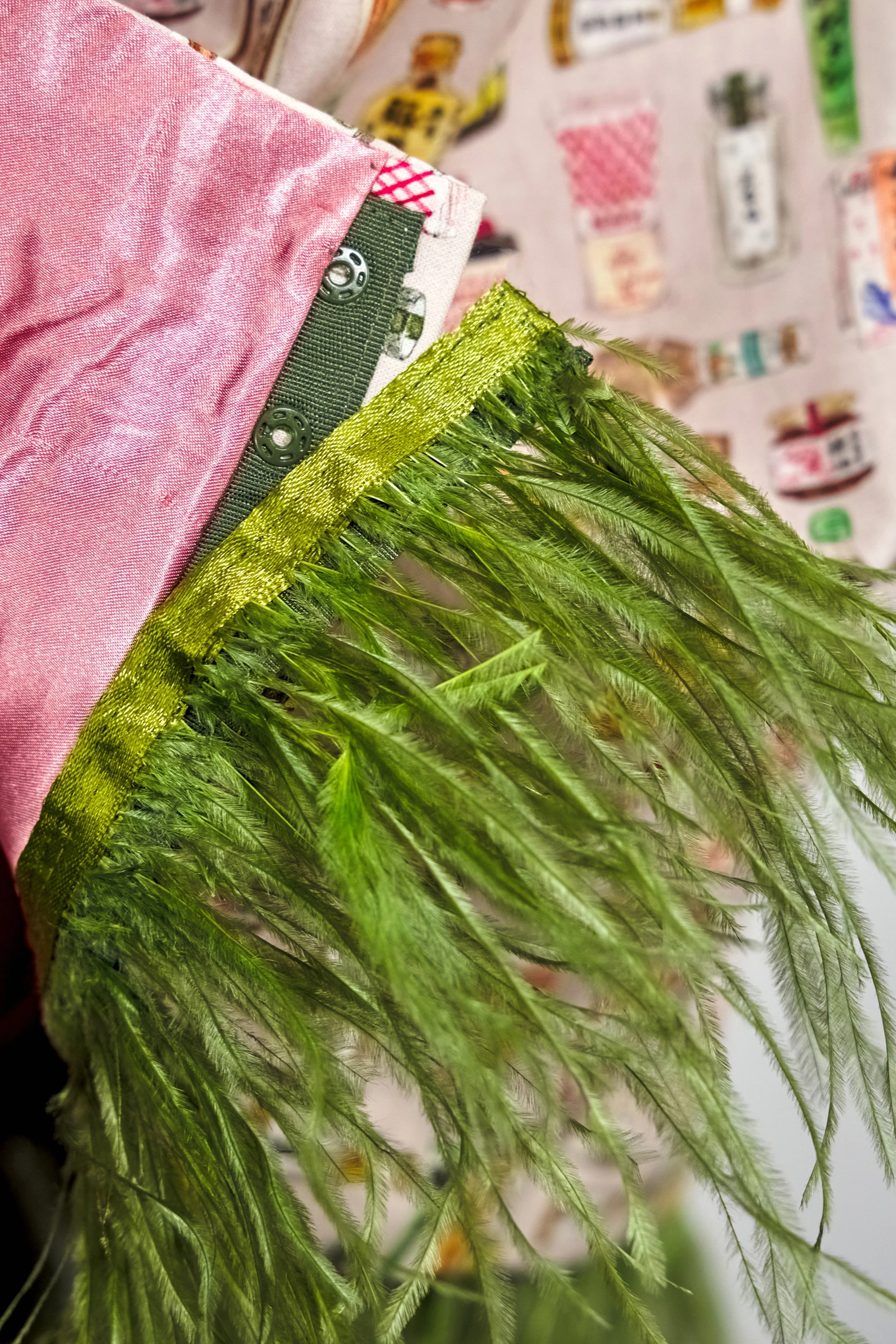 Close-up of wasabi-green feather trim and button attachment on Japanese print midi skirt — Wasabi Lover by B.Brand