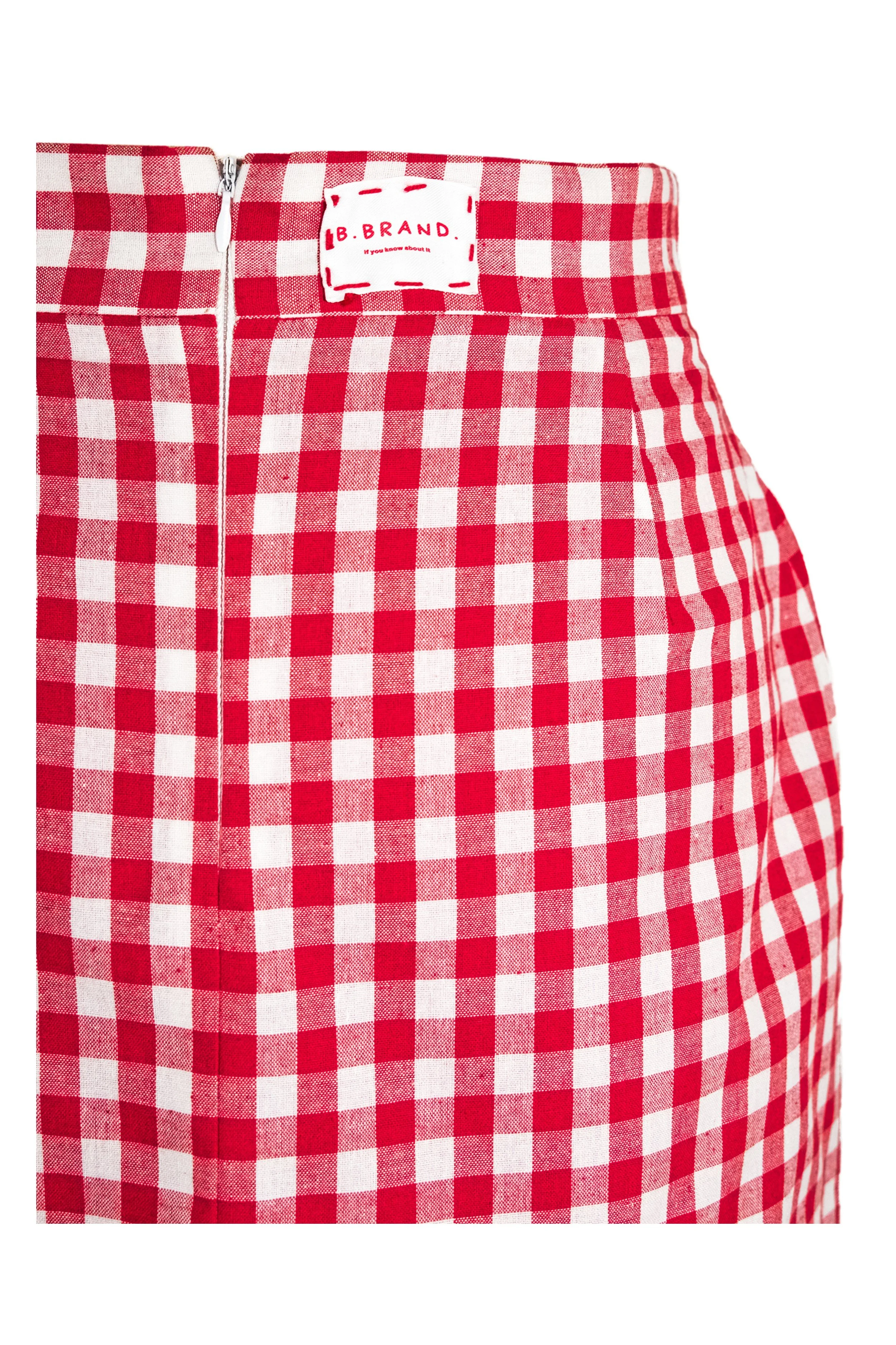 Close-up of B.Brand logo label and zipper on red gingham skirt waistband — Italian Table served with Basilico by B.Brand