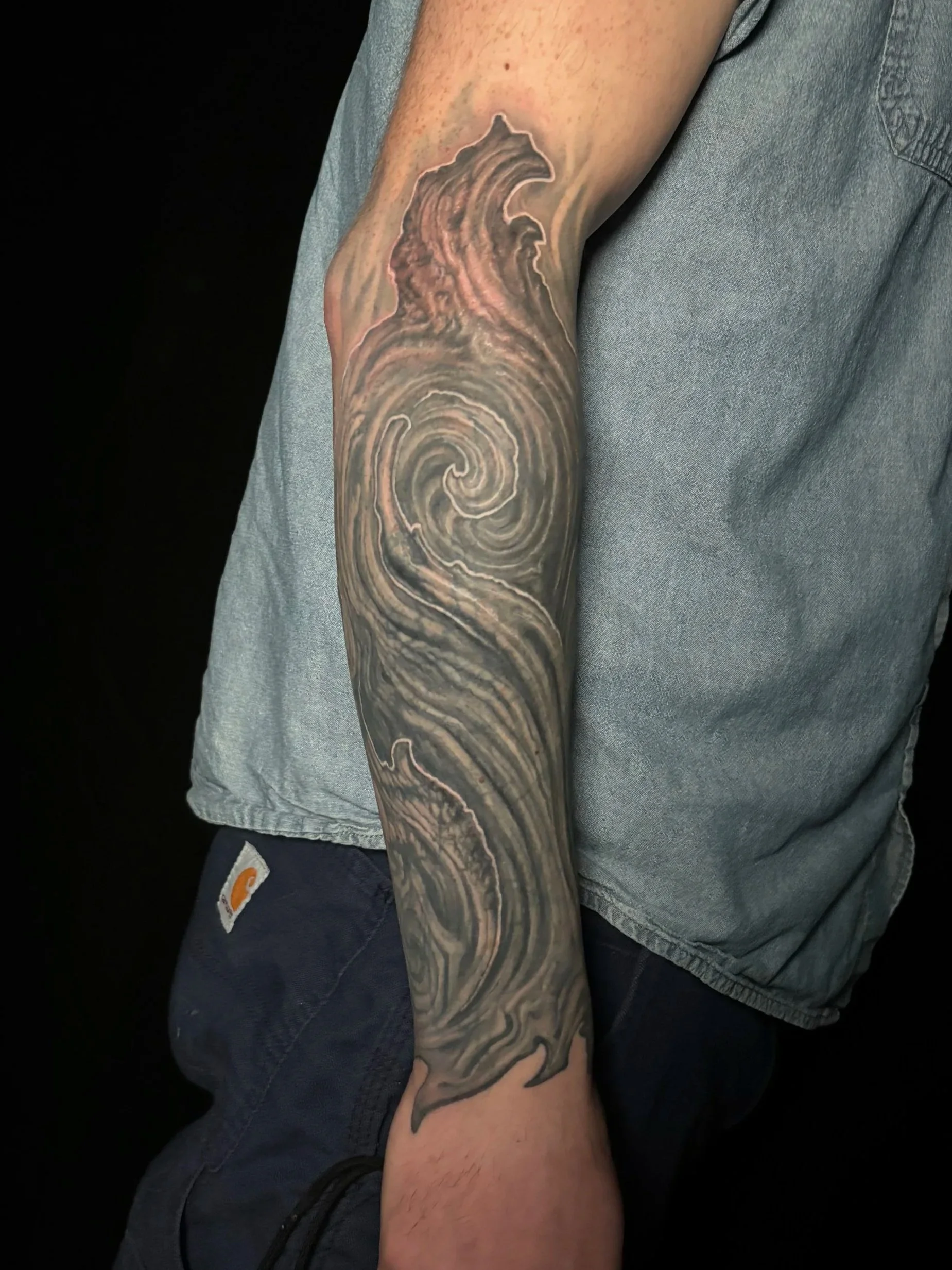 abstract textured stone biomech arm coverup tattoo