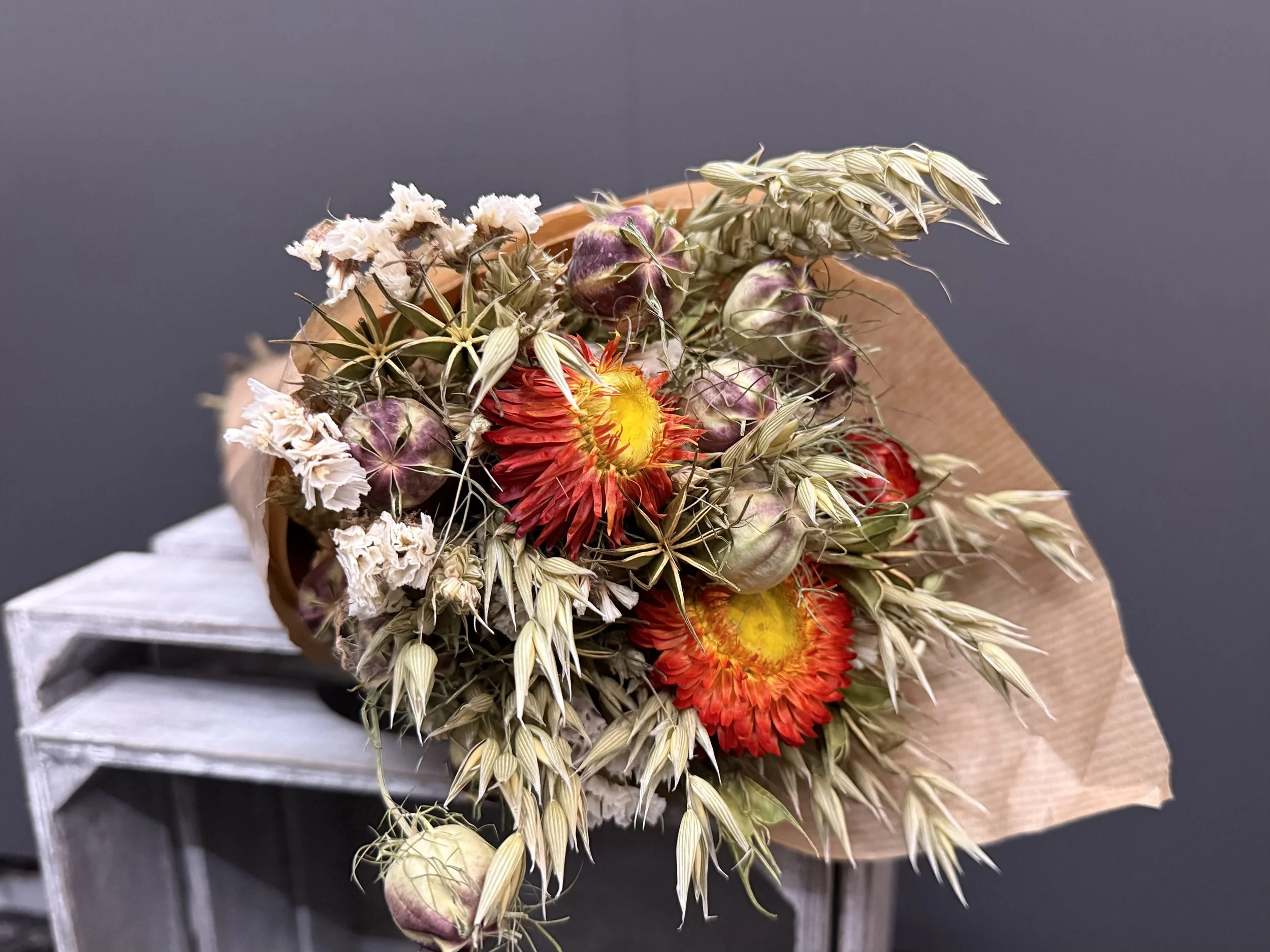 Dried Flower Bouquet Red with orange hue , whites , and natural tones.