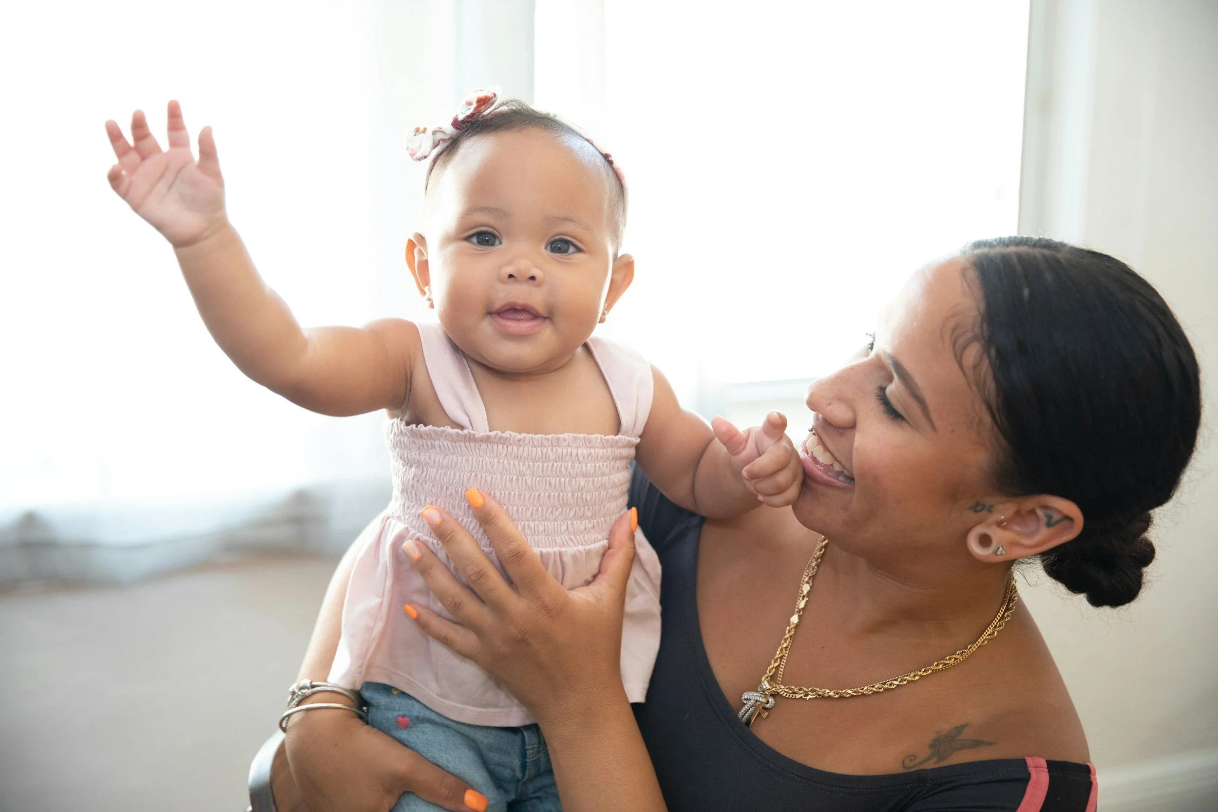 Mother and baby interacting with baby sign language.