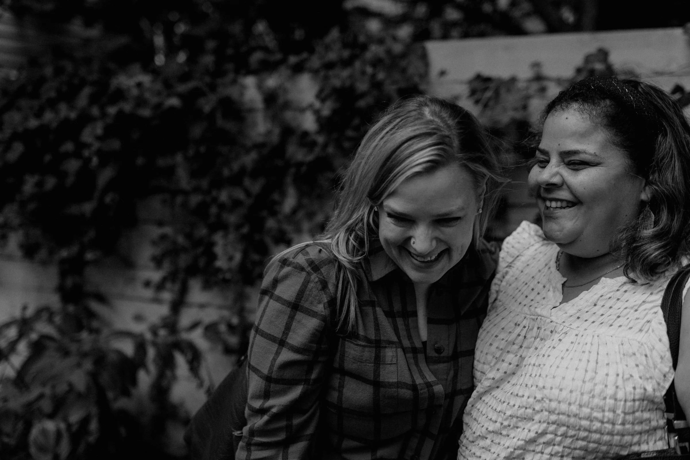 two women, laughing together