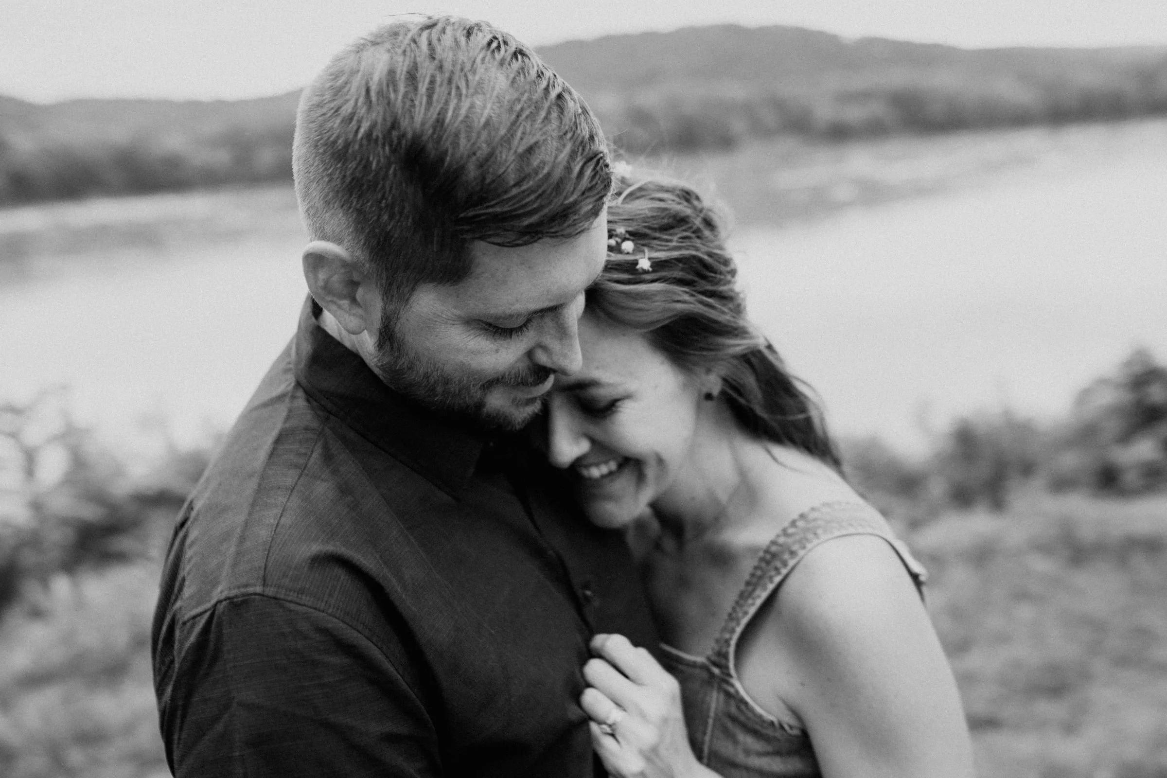 a couple laughing and holding one another