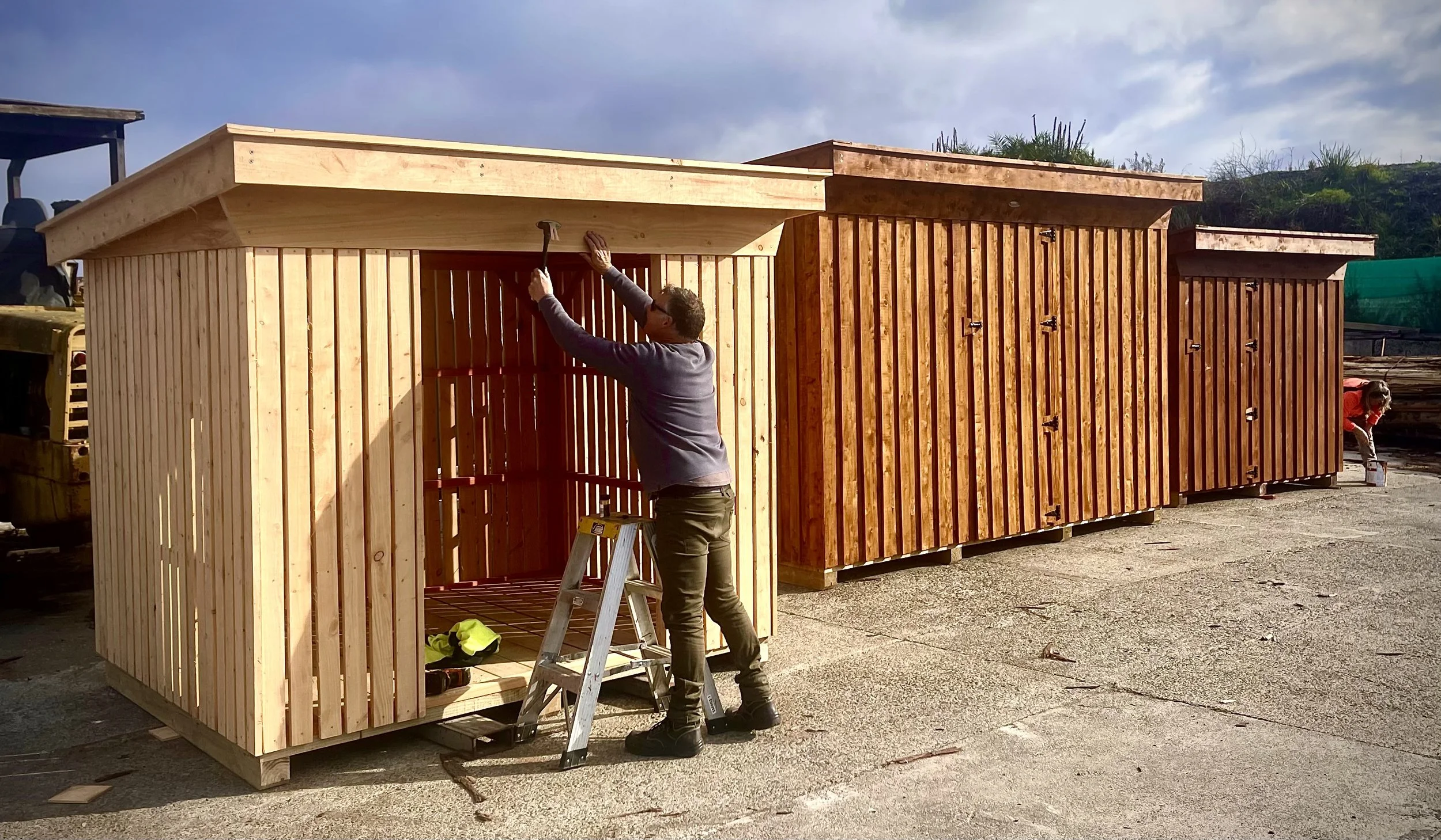 Putting the finishing touch on the firewood shed.