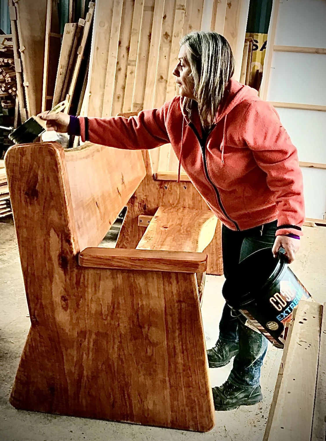 Oiling a Macrocarpa seat.
