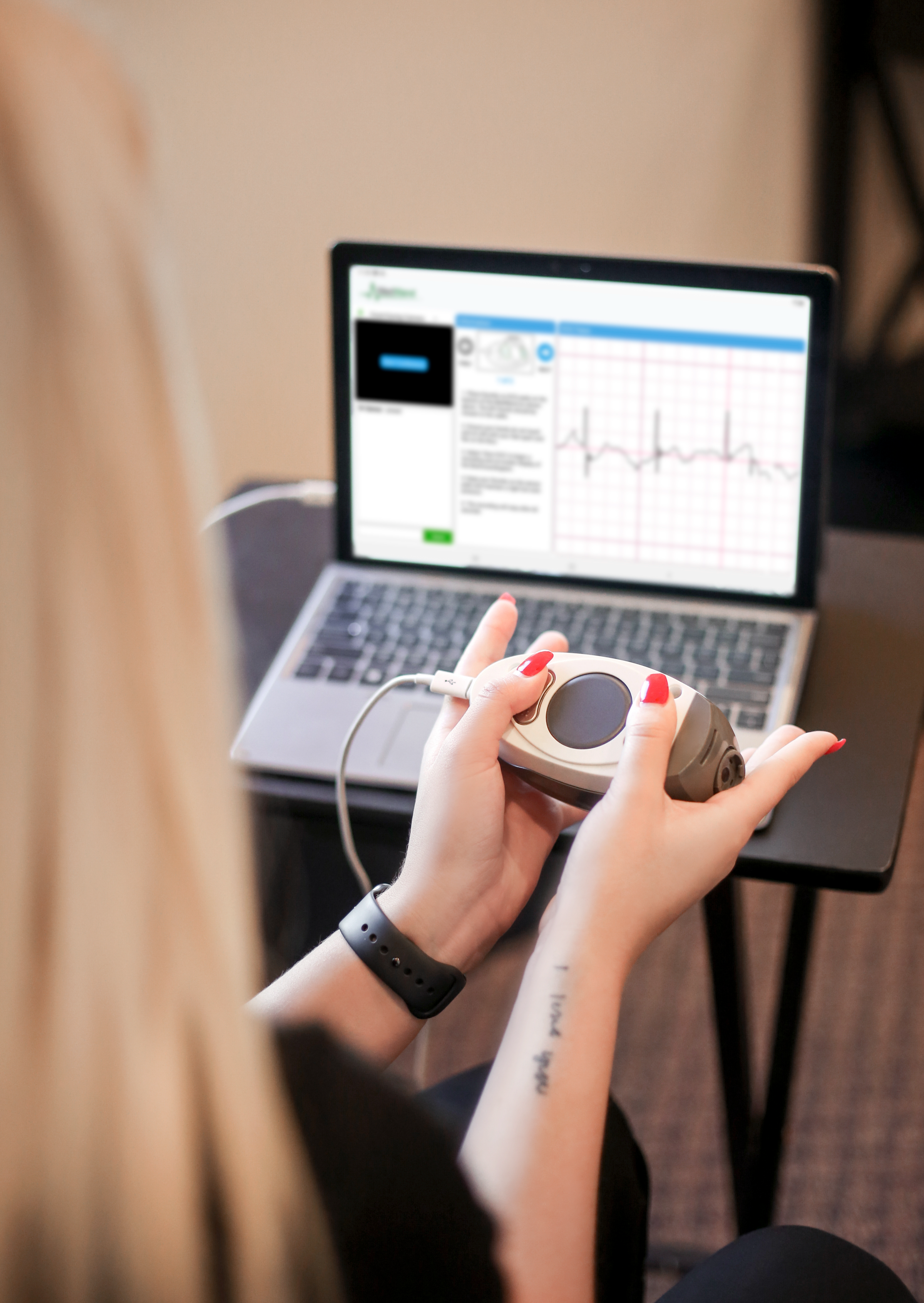 A kaimahi using a MedWand device during a clinical assessment