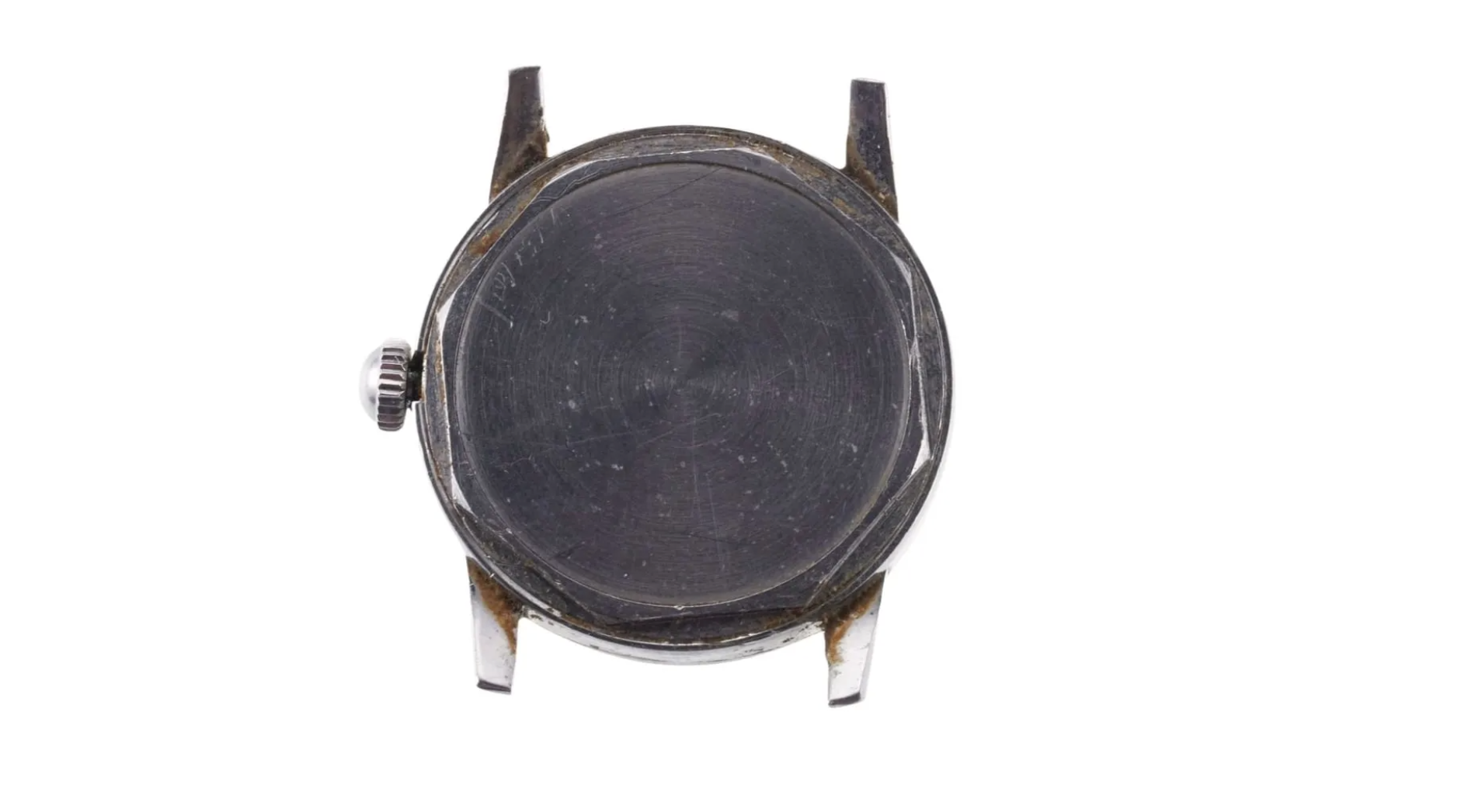 Top view of a round wristwatch with a black face, silver case, and a side crown, showing signs of wear and scratches.