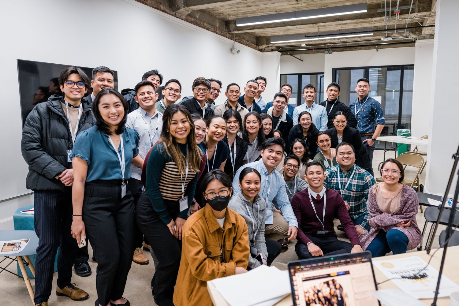 A large group of CYFAM members smiling together at a CYFAM gathering.