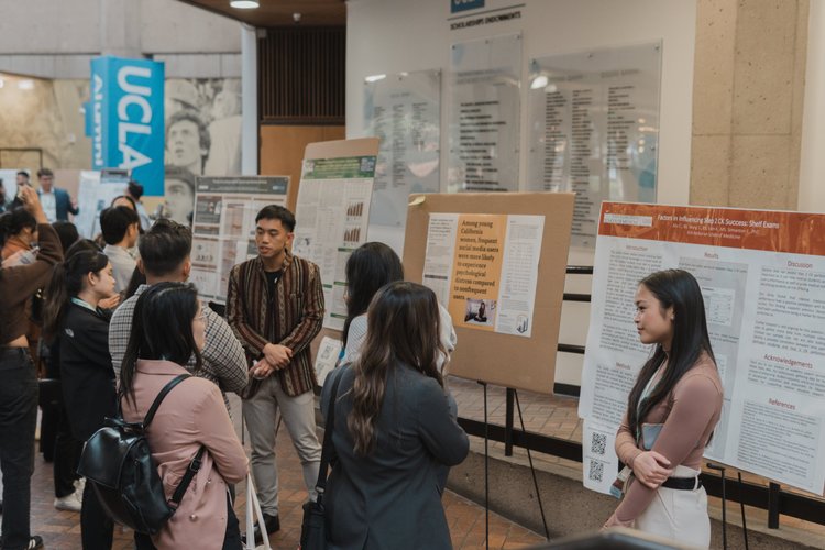 An attendee reads a research poster during the poster session.