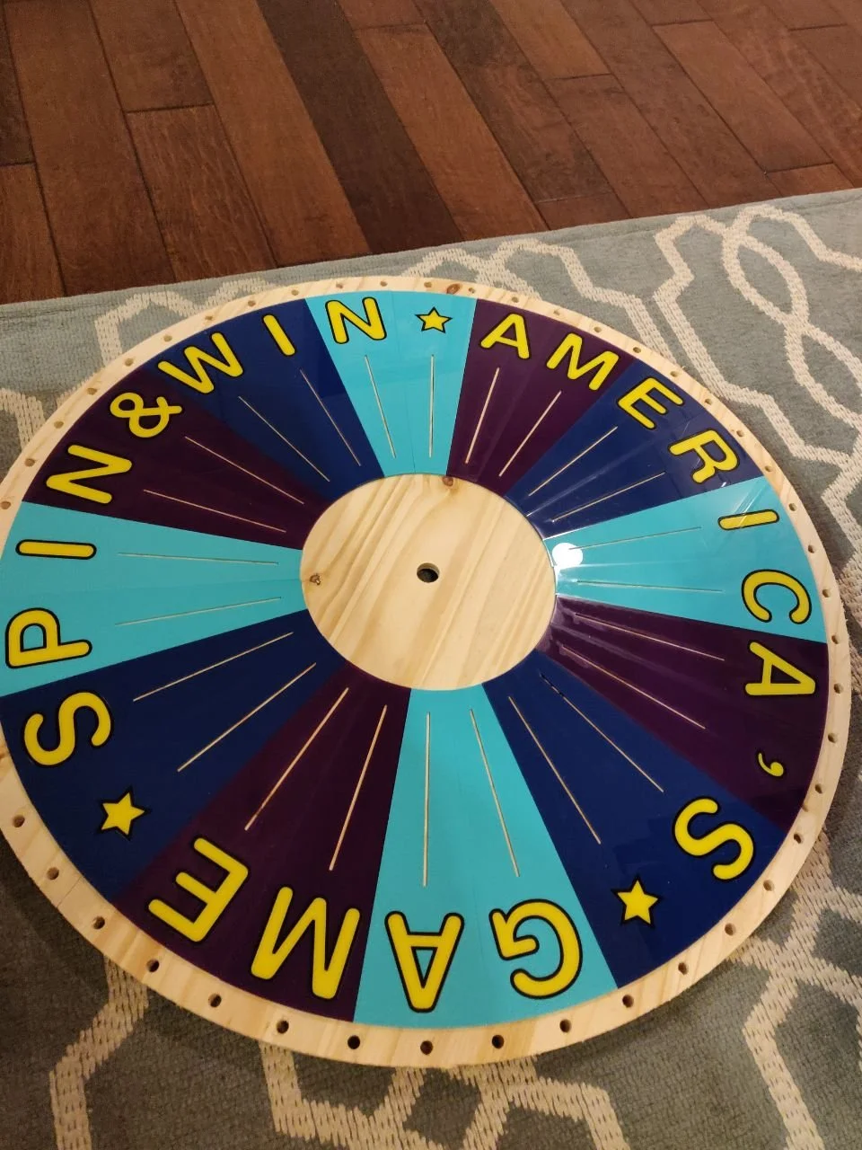 Laser-cut acrylic design laid on top of the bonus wheel plywood round.