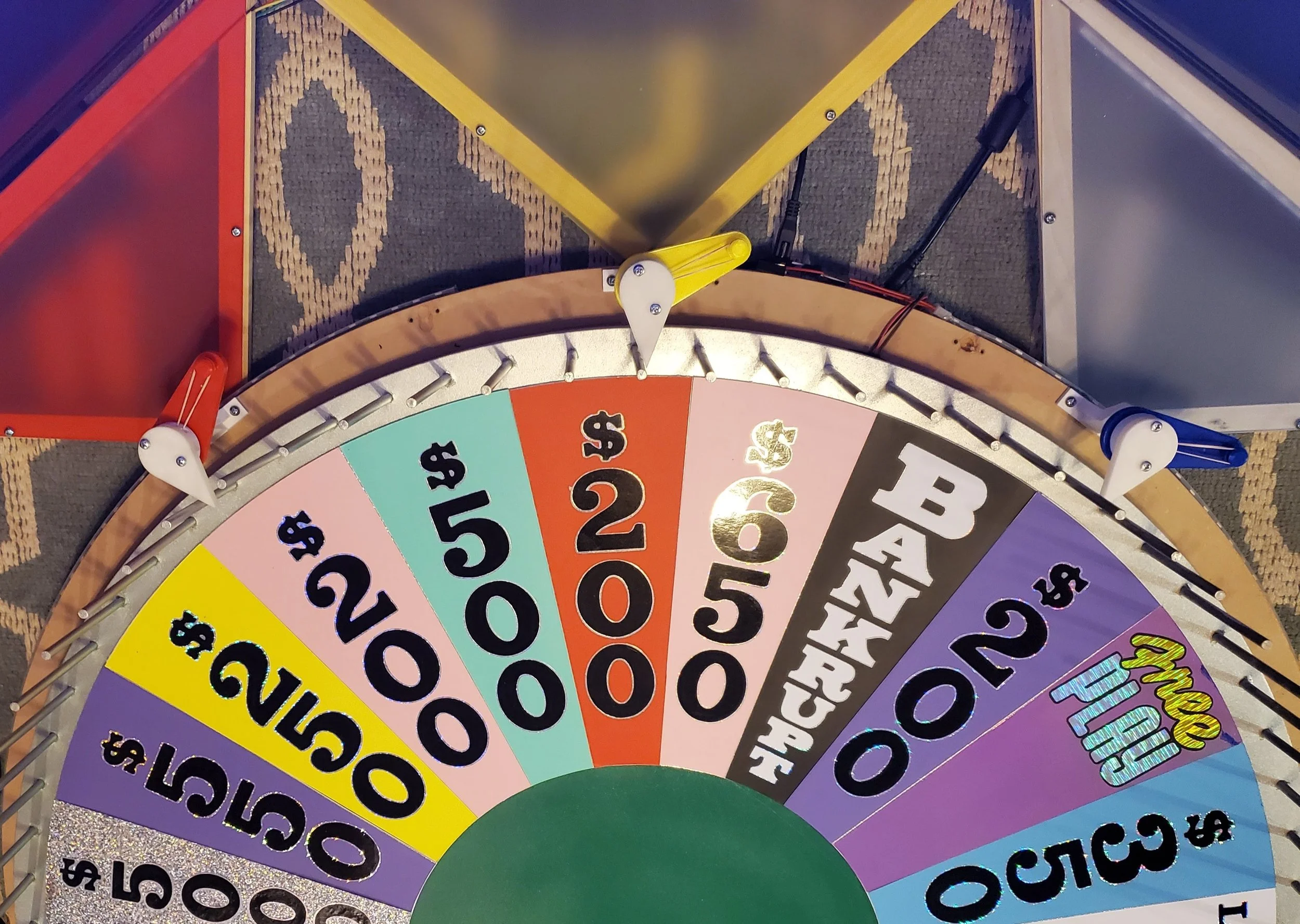 Photograph of the Wheel of Fortune where the acrylic part of Player podiums are visible.
