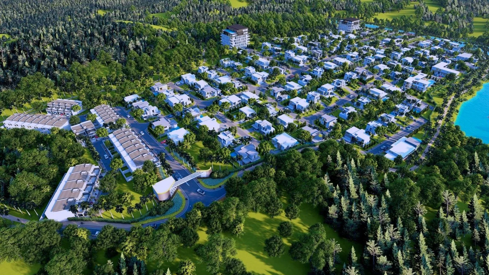 Aerial view of a modern residential community surrounded by trees and greenery, with a body of water on the right.