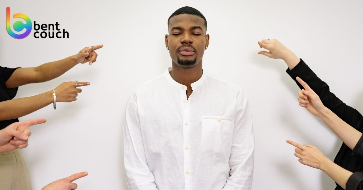 An overwhelmed man surrounded by pointing hands, symbolising people pleasing, pressure to meet others' expectations and the difficulty of setting healthy boundaries.