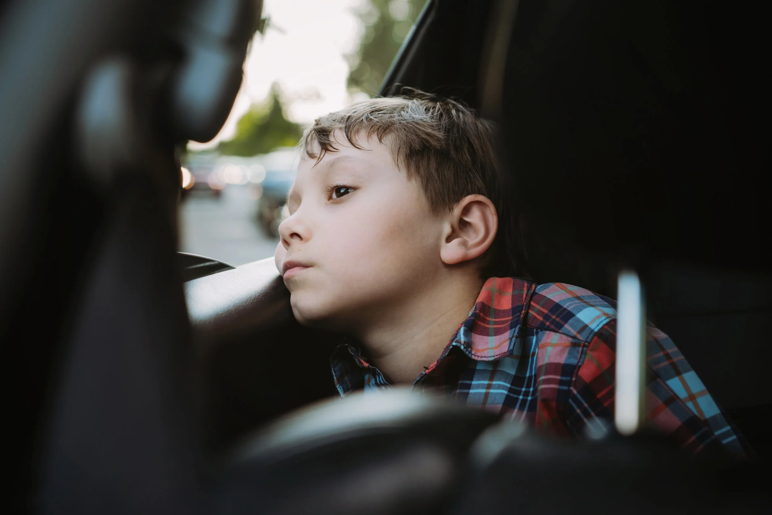 Boy staring out of car window