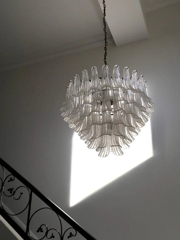 Introducing PROJECT MARMOR 

This light selection defines this space. 

The chandelier's form, illuminated by natural light, creates a striking visual. 

 Demonstrating how thoughtful lighting choices can make an interior.