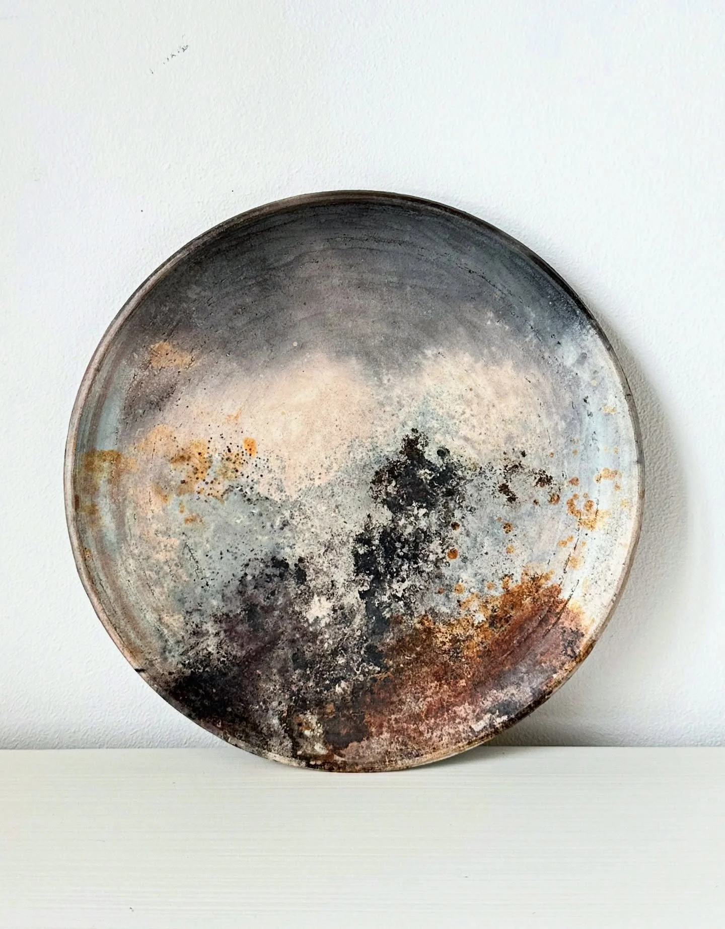 A pit fired plate, like a stormy landscape 

I&rsquo;d like to say I could take credit for the composition of the markings, but really I think it&rsquo;s the fire that does the work. These colours were made in 6 hours of outdoor firing with wood, and
