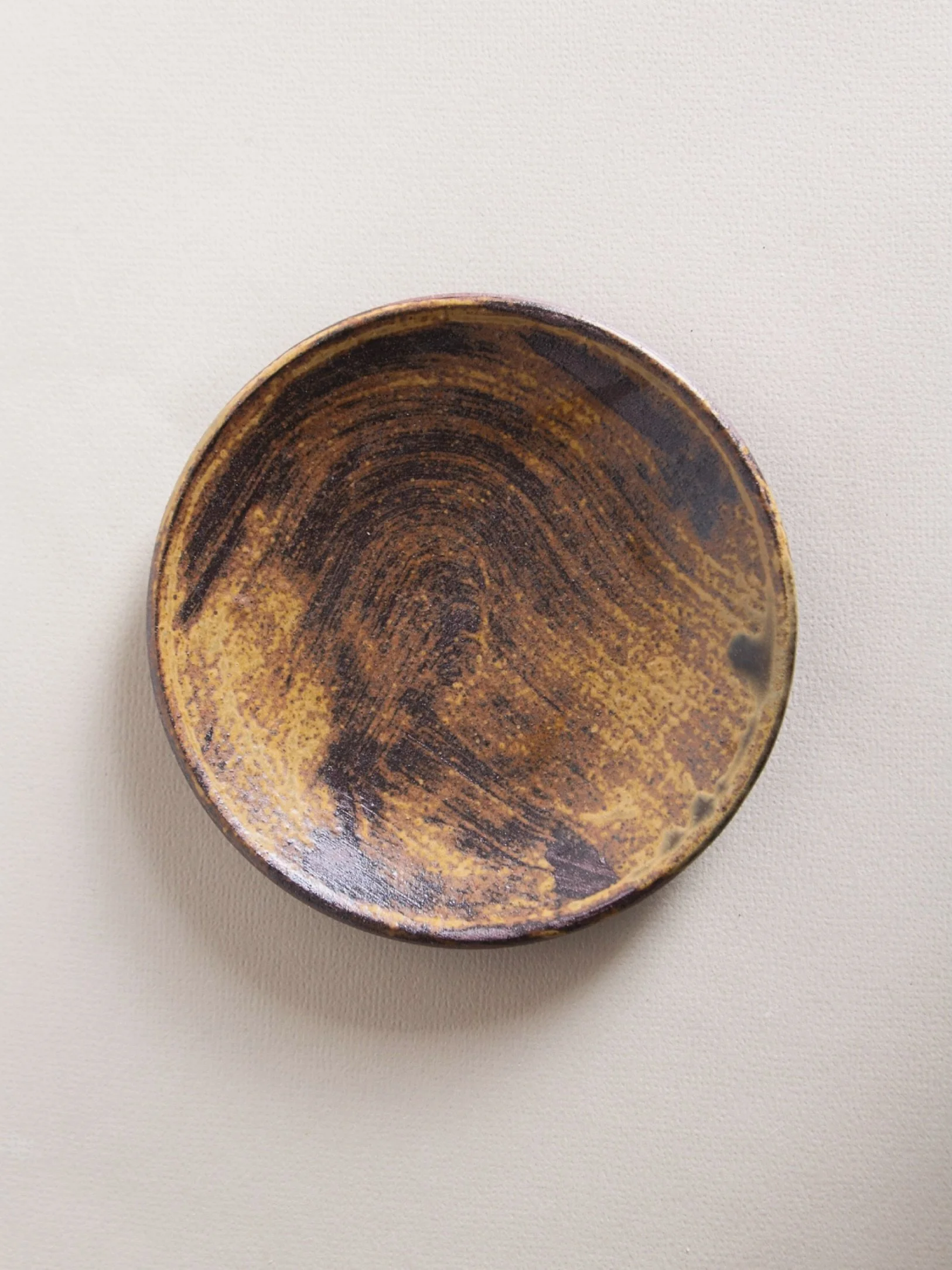 Wild clay slip on terracotta. Nice to get some tonal depth as well as brush strokes that sit well into the form of this little dish
