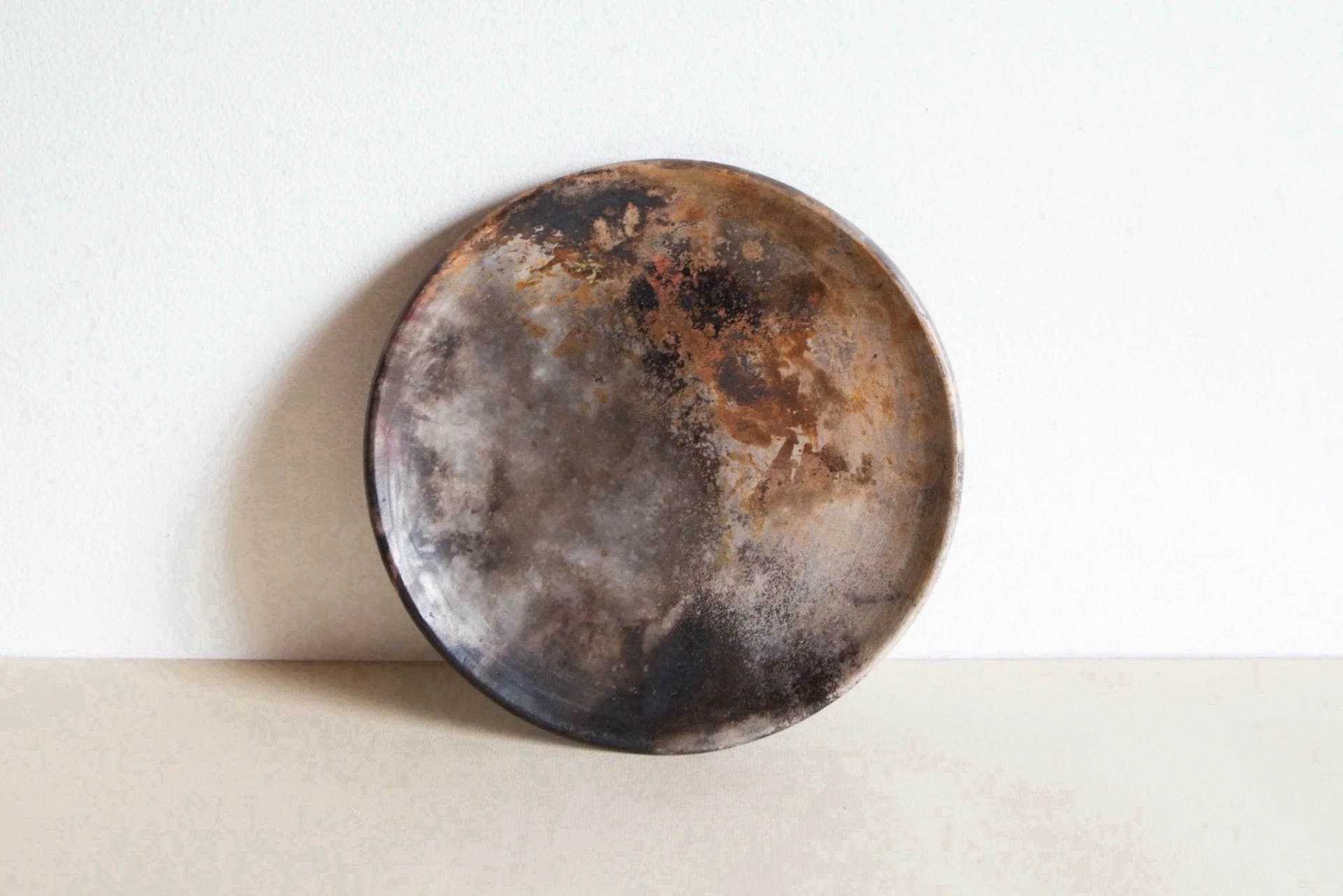 Pit firing is a bit unpredictable, but this piece picked up a lot of smoky colour and deep rusty oranges that make it pretty special. Once it&rsquo;s been polished with beeswax, the smooth surface almost doesn&rsquo;t look or feel like ceramic at all
