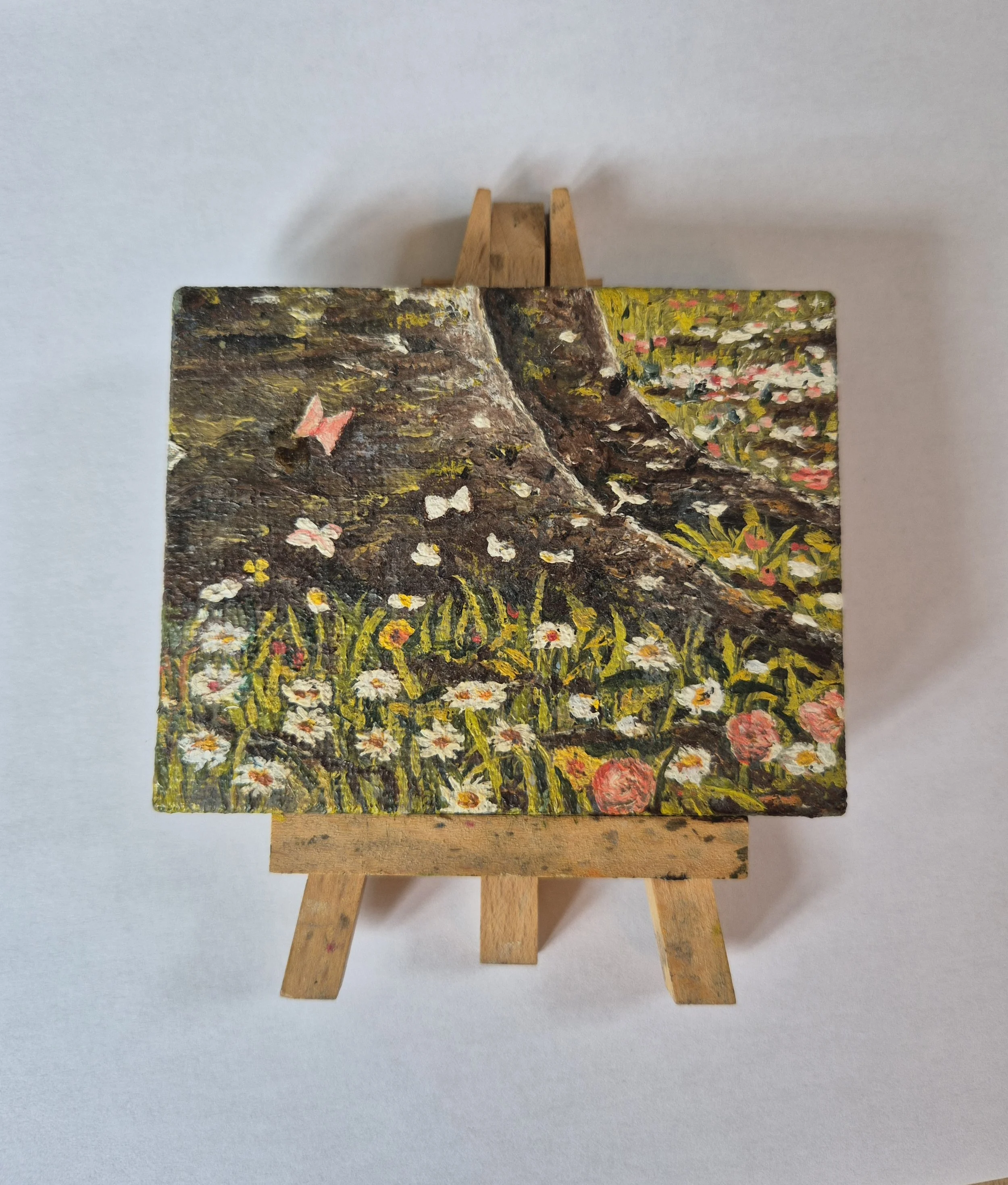 Miniature oil painting on tiny easel of tree roots and wild flowers by JC Barber