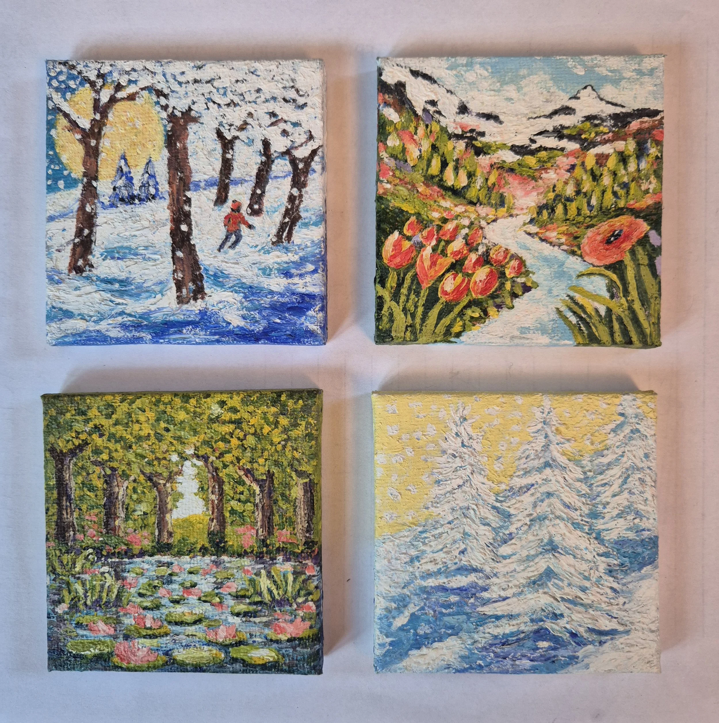 Four miniature seasonal landscape oil paintings including winter and summer scenes