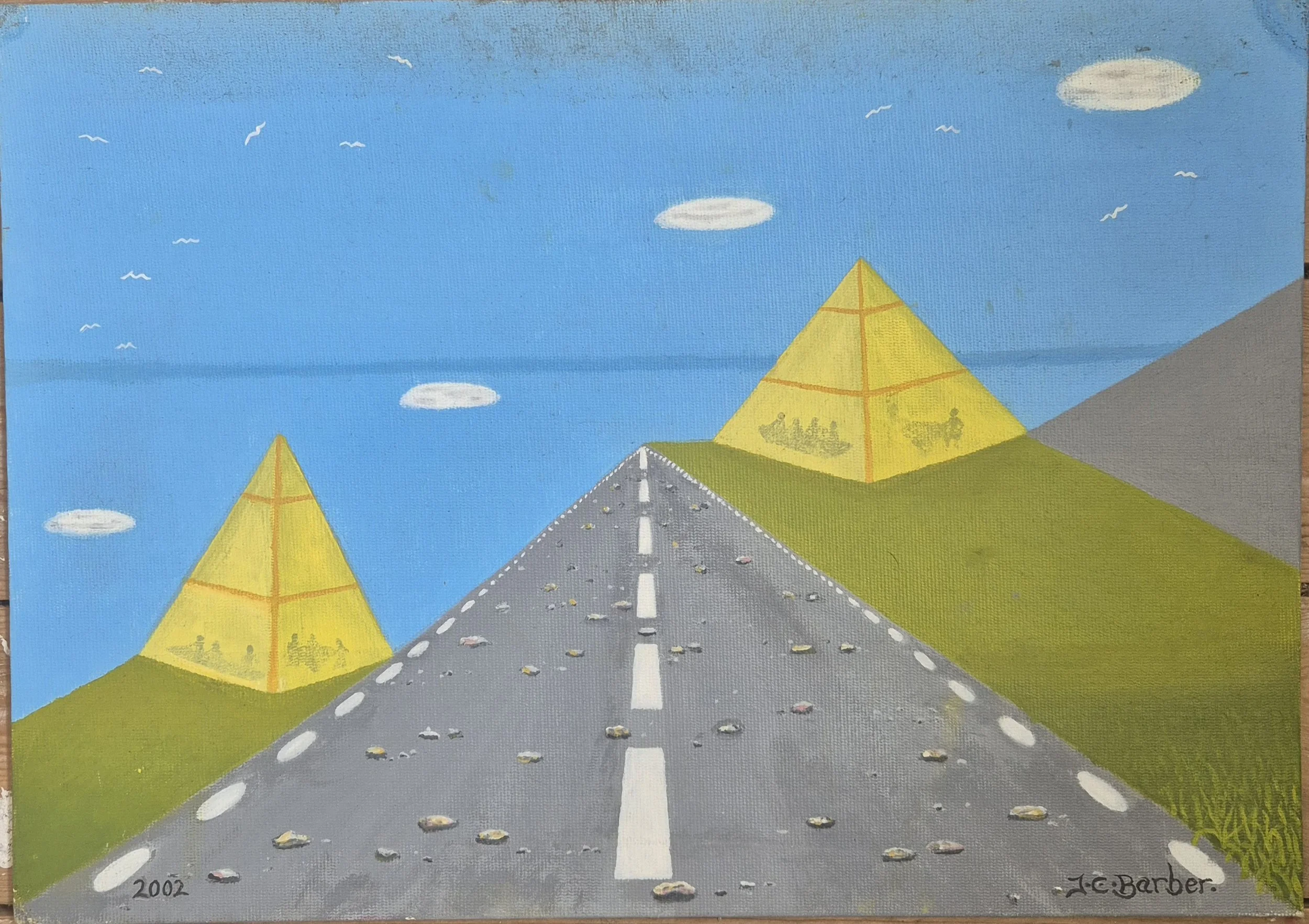 An early surreal oil painting by artist JC Barber, painted in 2002. The artwork features a long, straight grey highway leading into the distance toward two golden yellow pyramids, set against rolling green hills and a bright blue sky, stylized clouds