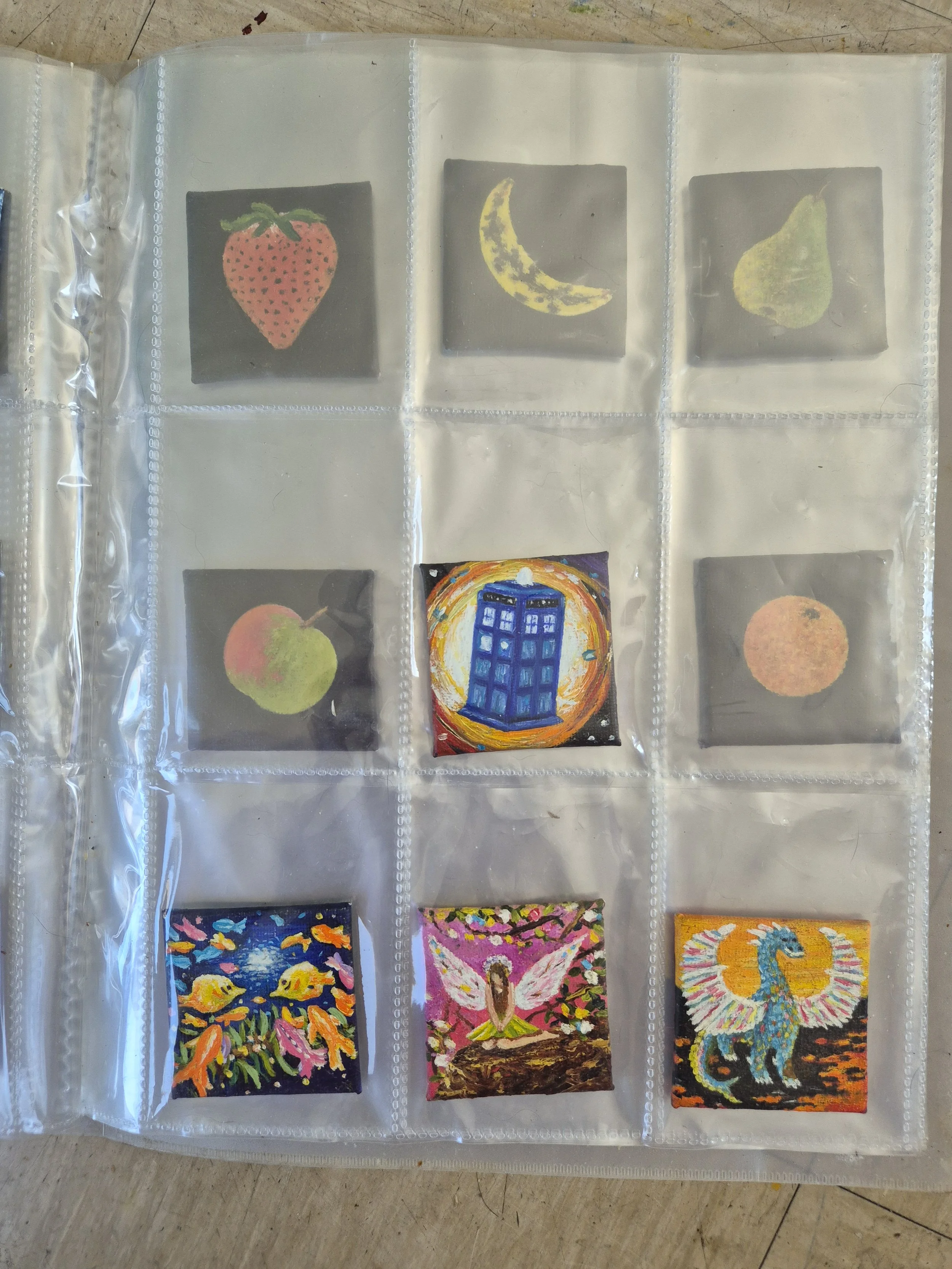 Archival binder page of original micro-miniature oil paintings by JC Barber