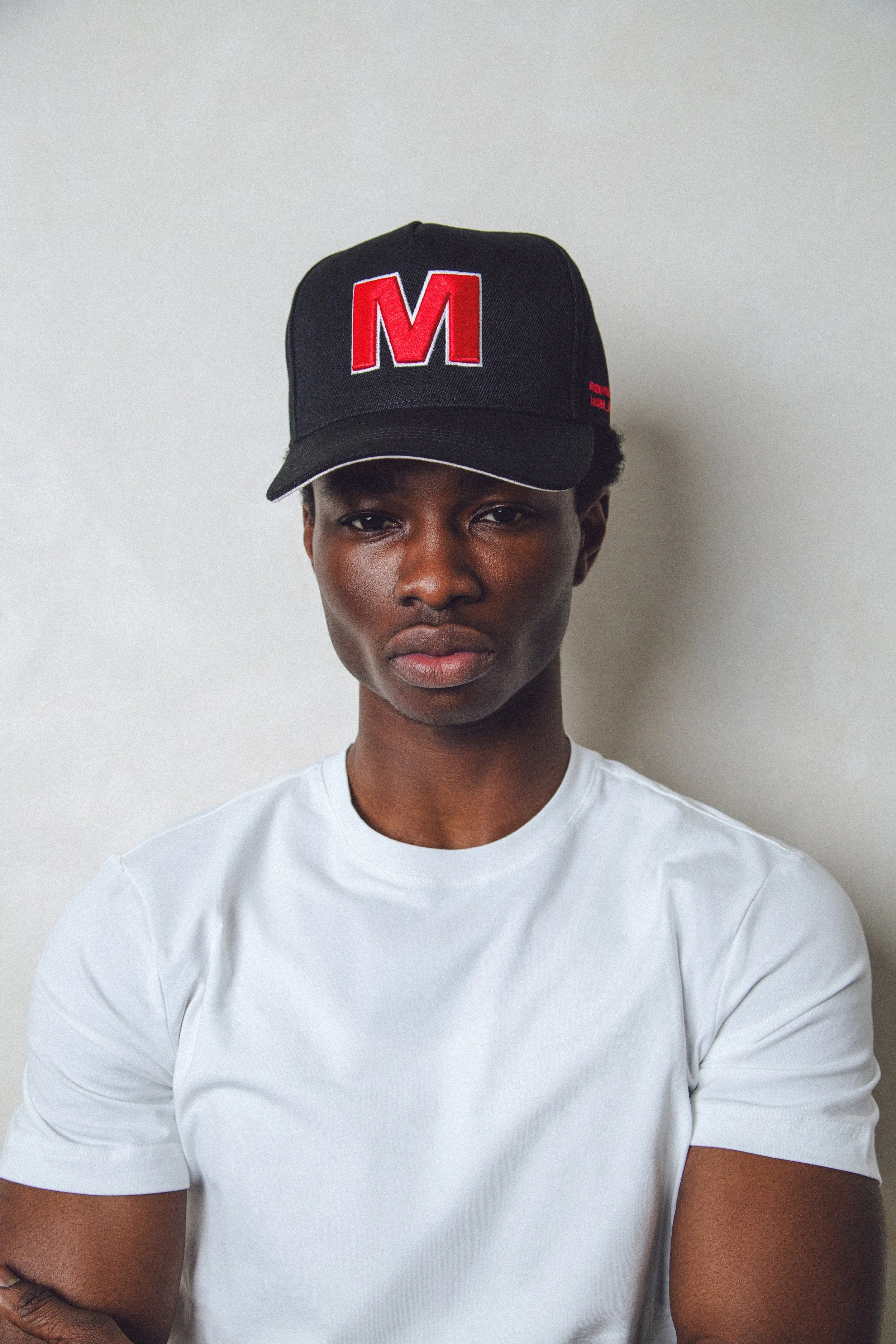Black Snapback Cap with Red 'M' Emblem