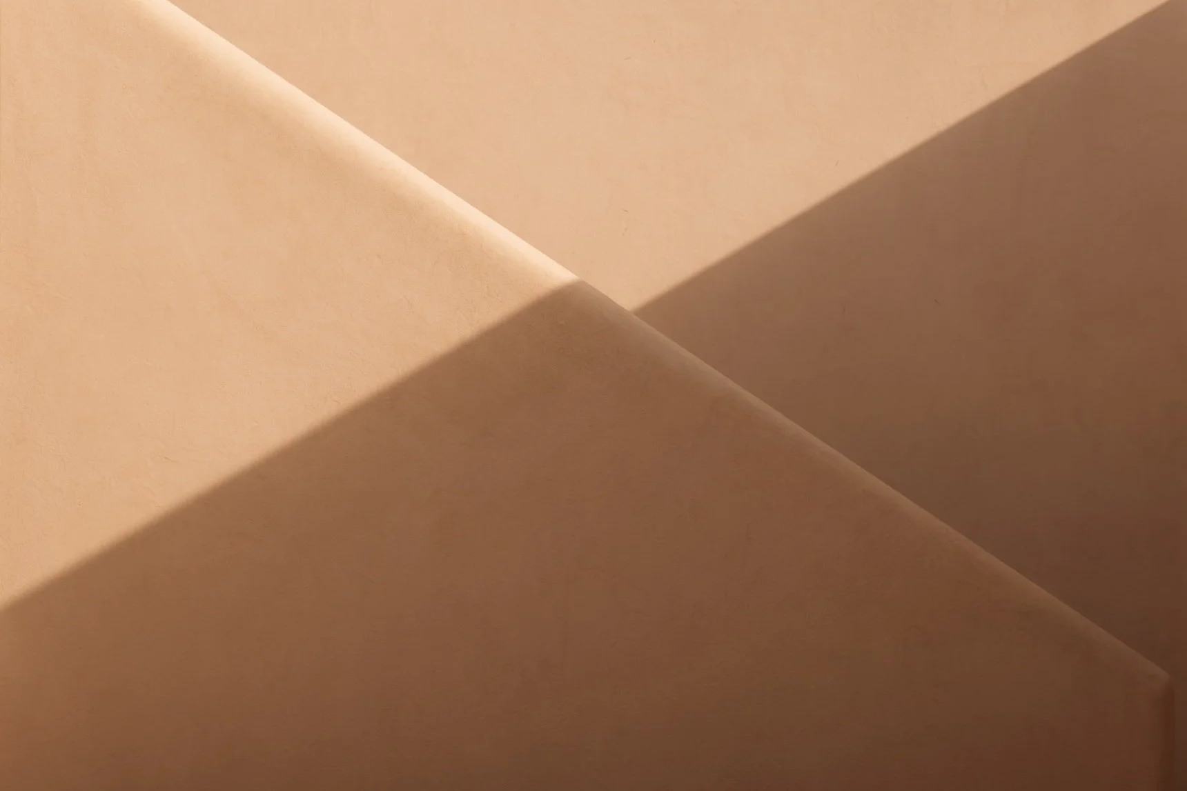 Close-up of intersecting beige paper or cardboard surfaces with shadows Royal Mansour Tamuda Bay Morocco. Photography Sophia van den Hoek