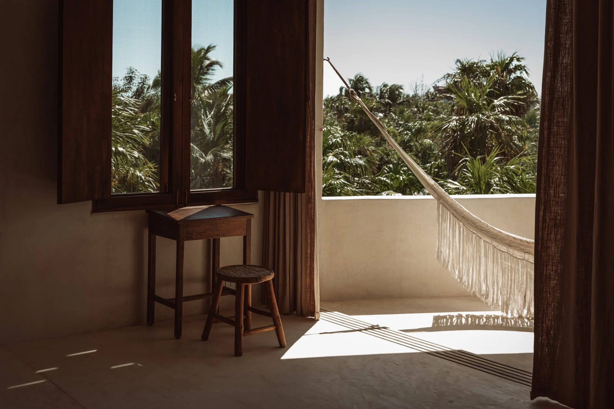 Hammock on balcony overlooking jungle canopy — slow-living hospitality style. Tulum by Sophia van den Hoek