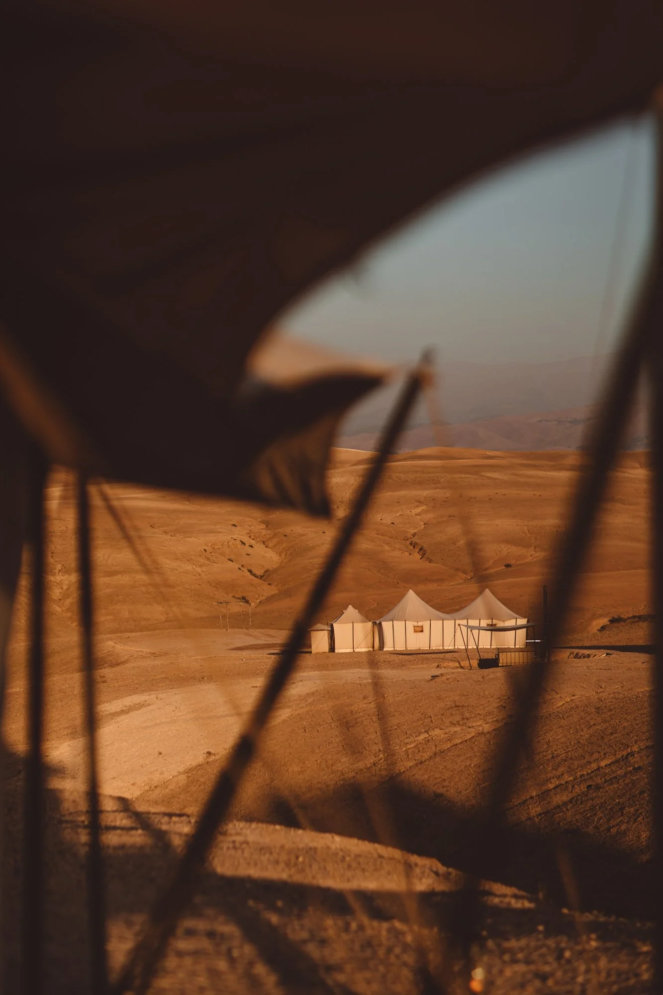 Quiet luxury in the Moroccan desert. Scarabeo Camp captured in warm ochre tones, natural textures and nomadic serenity. Studio Unfolded photography.