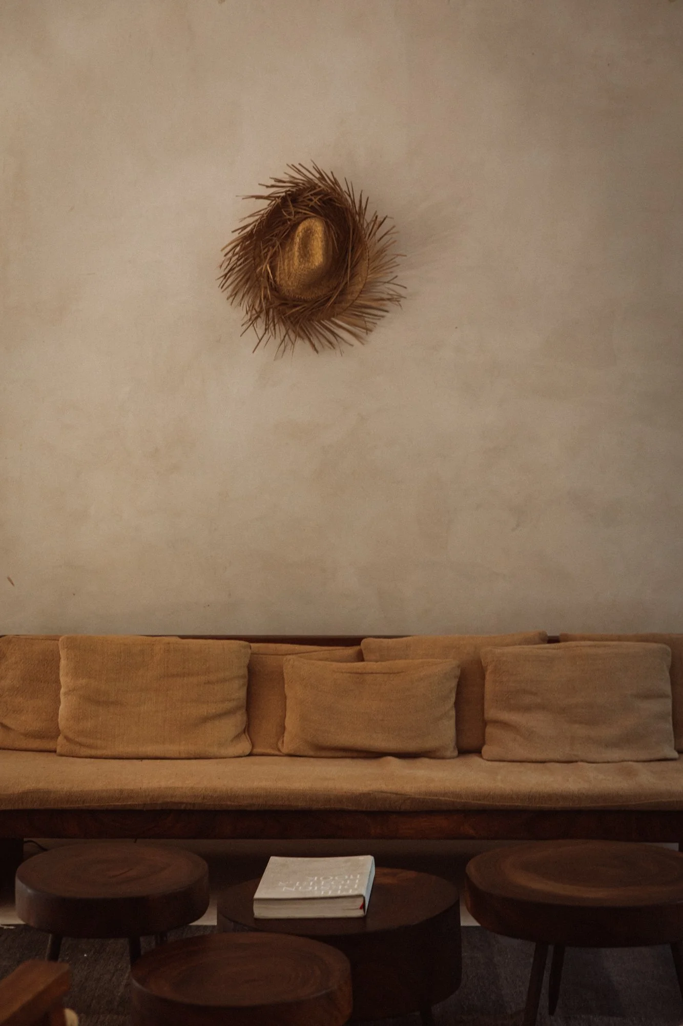 Built-in dining bench with handcrafted wood table — warm minimal design in Tulum Treehouse boutique stay. Photo by Sophia van den Hoek
