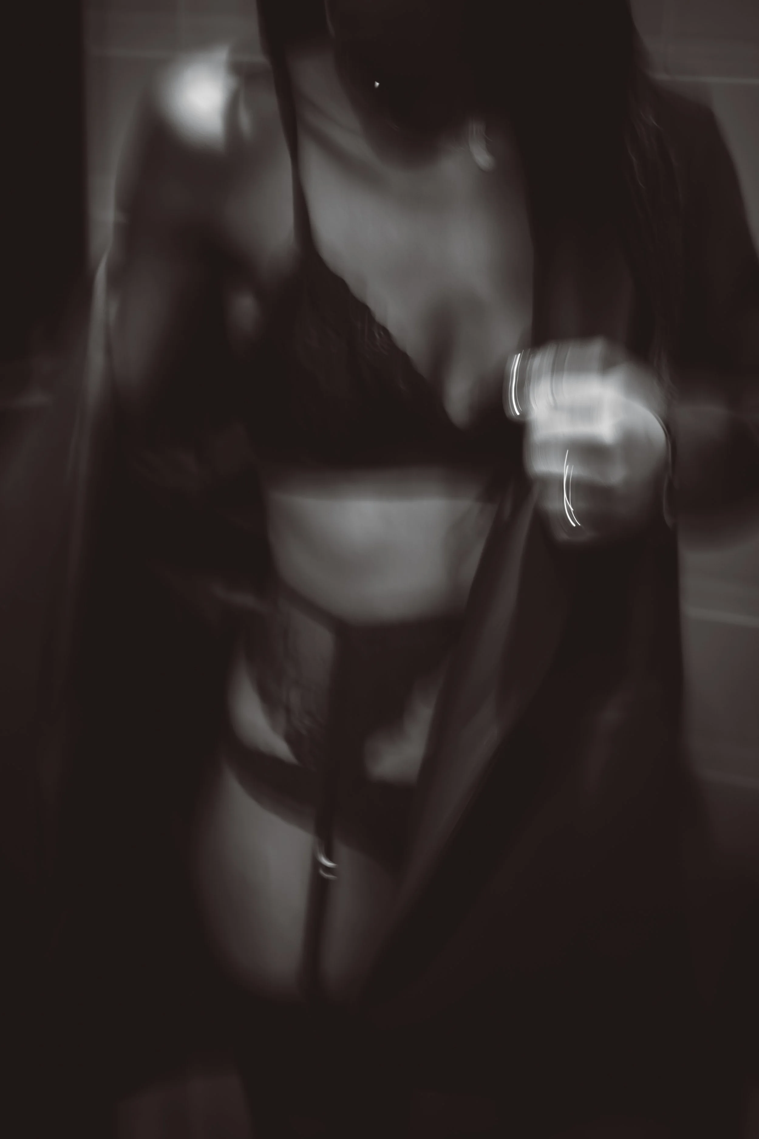A woman in a mirror wearing lingerie in black and white. Restaurant Putaine, Rotterdam, The Netherlands