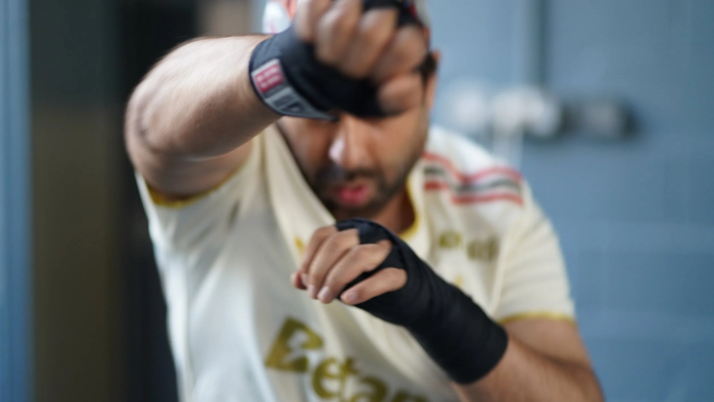 man throwing a right punch to connect with the punch bag in North Finchley