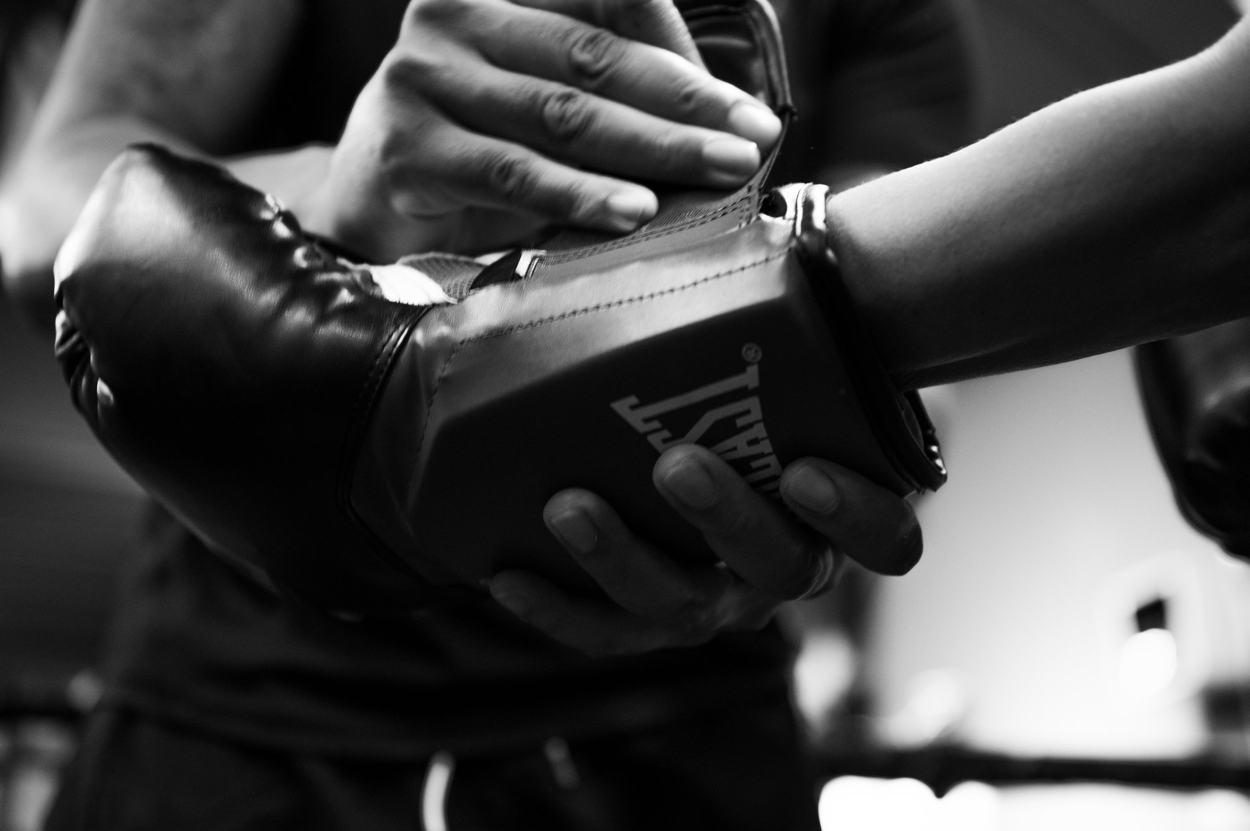 helping to do up boxing gloves for a session in Camden Town