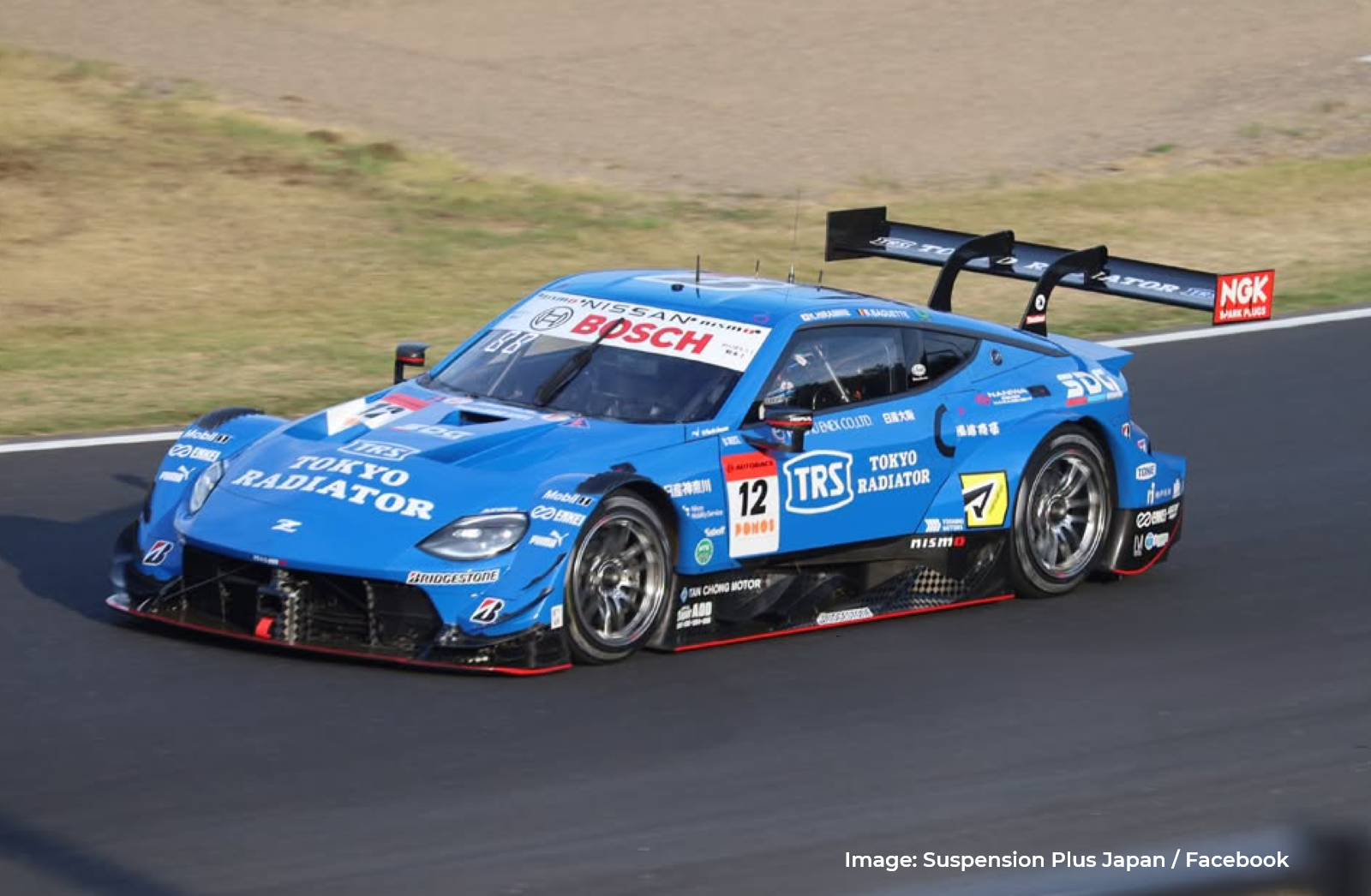 Blue TRS IMPUL with SDG Nissan Z NISMO GT500 carrying the Suspension Plus logo on its rear-wing support.