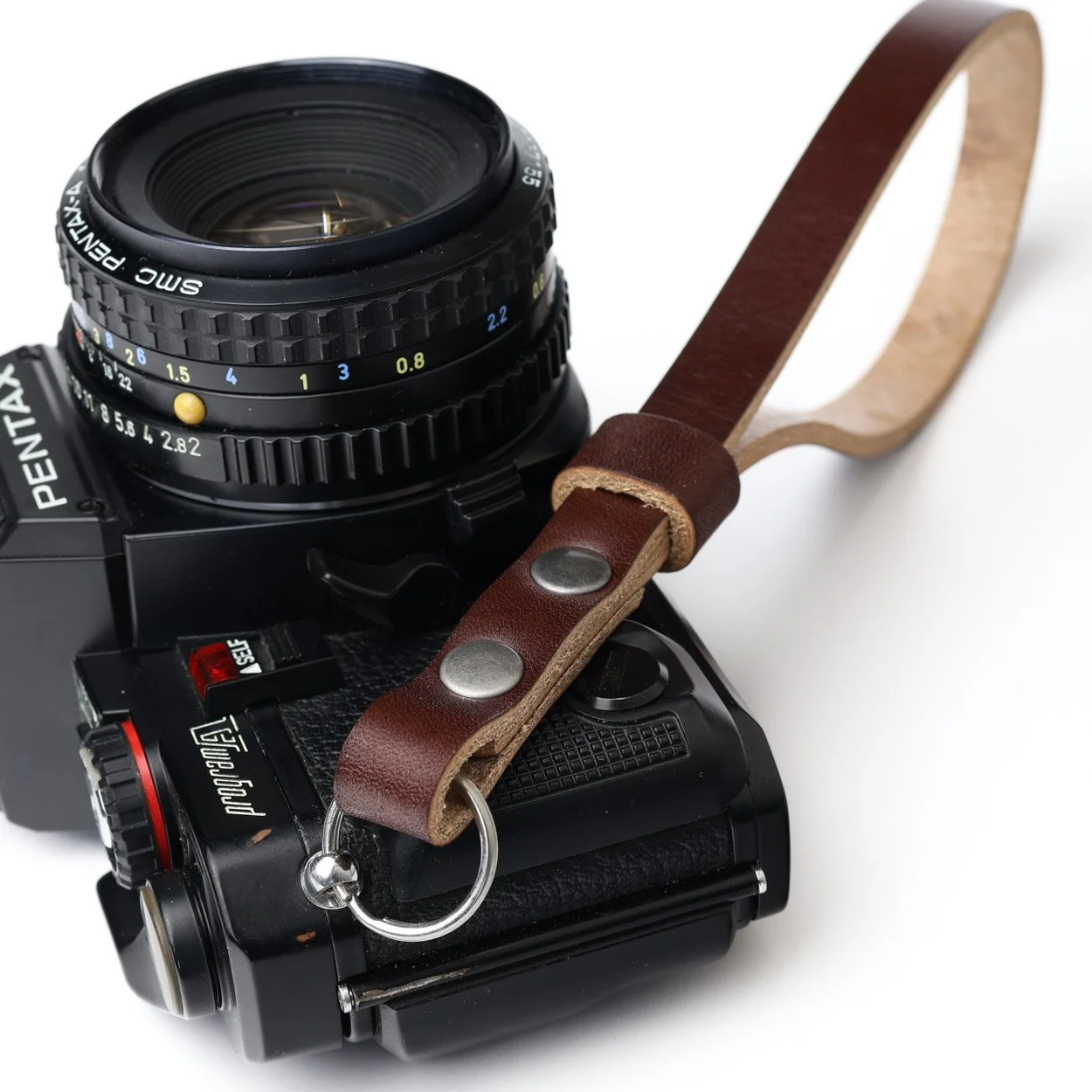 camera wrist strap close-up on a black Pentax