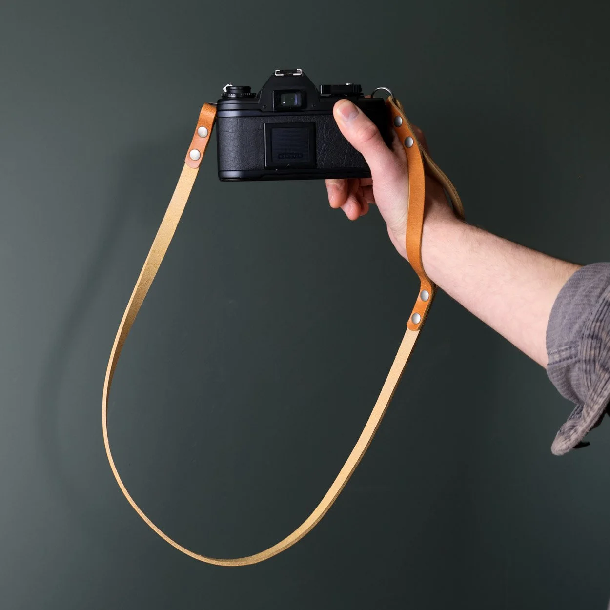 Peak leather camera strap featuring wrist strap