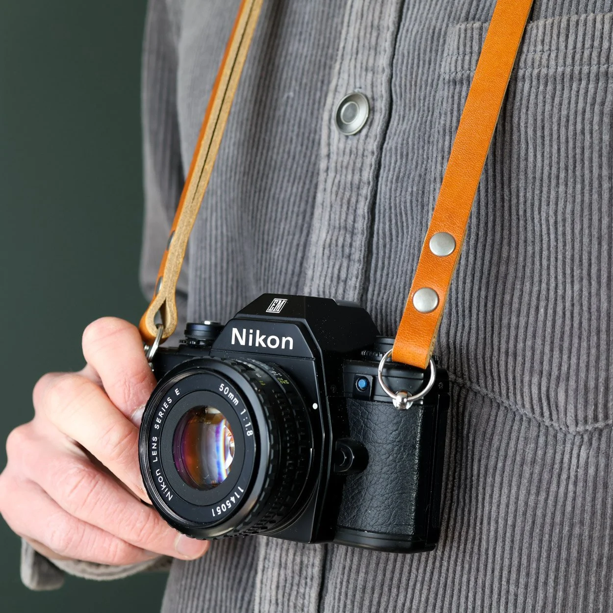 whiskey peak camera strap close up with Nikon film camera