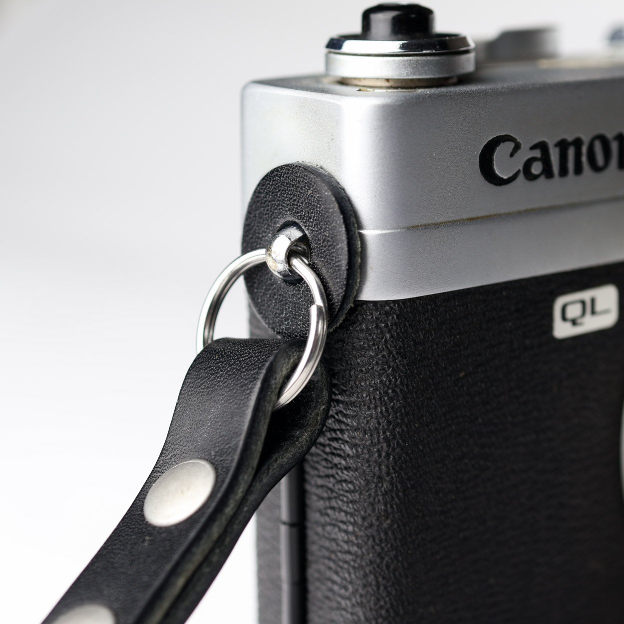 Black leather camera strap lug protectors