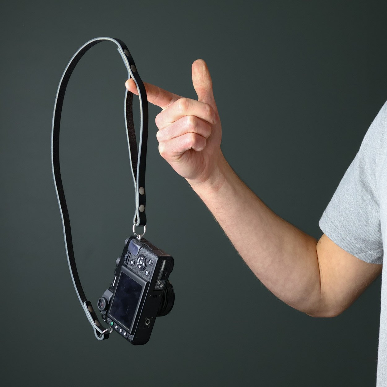 Peak leather camera strap that is a dual purpose neck and wrist strap. Shown here with Fujifilm camera