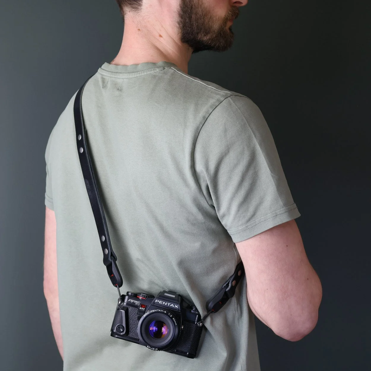 Camera sling peak design leather camera strap worn crossbody with Nikon film camera