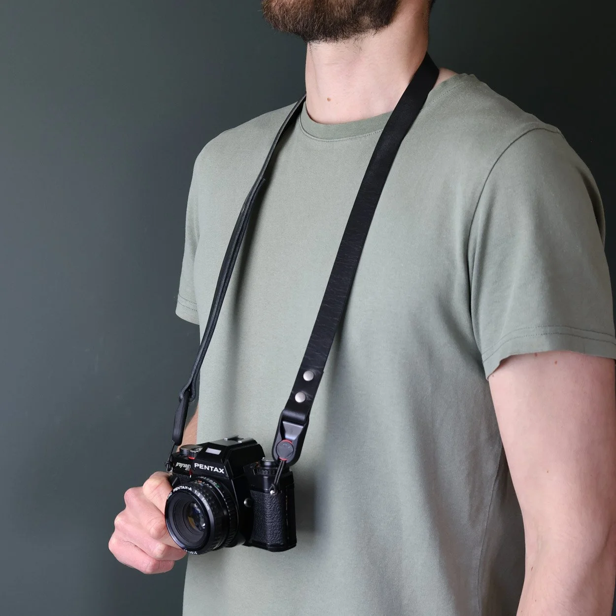 black quick release camera neck strap with vintage pentax film camera