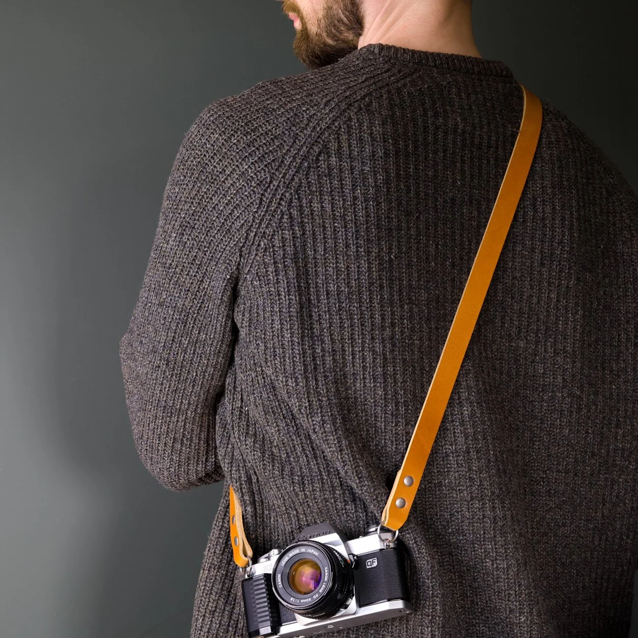 Vantage leather camera sling worn crossbody with Canon 35mm film camera