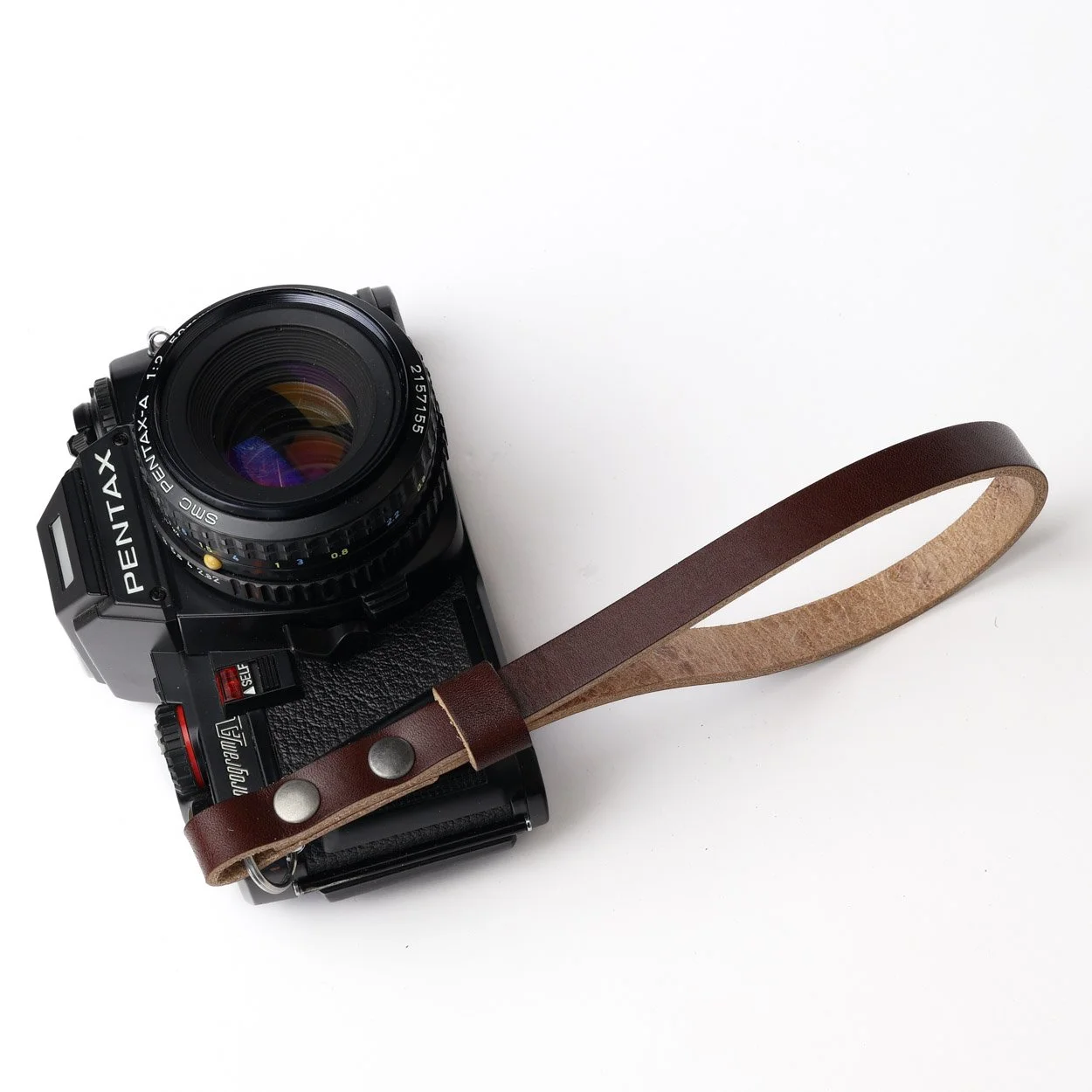 Flint leather camera strap bowman leather handmade in the UK with a vintage Pentax film camera
