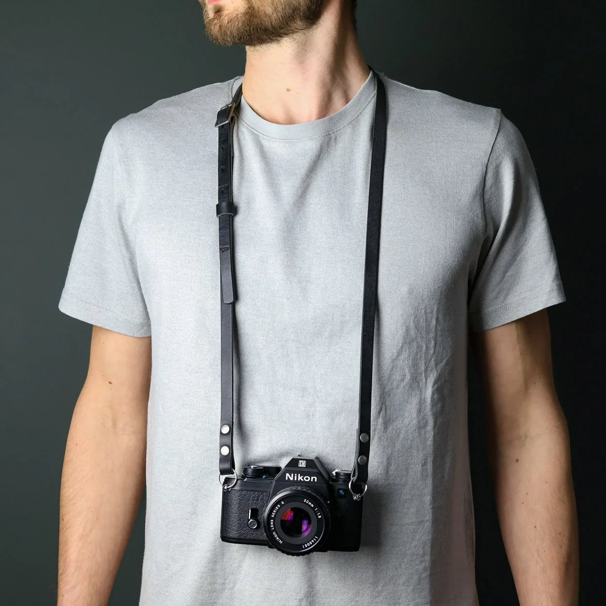 Black leather adjustable camera strap neck strap with a Nikon camera