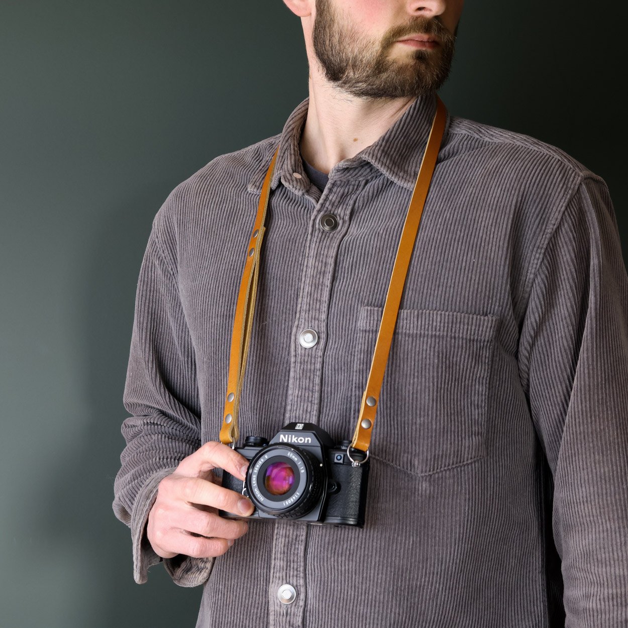 leather camera neck strap whiskey with vintage Nikon camera
